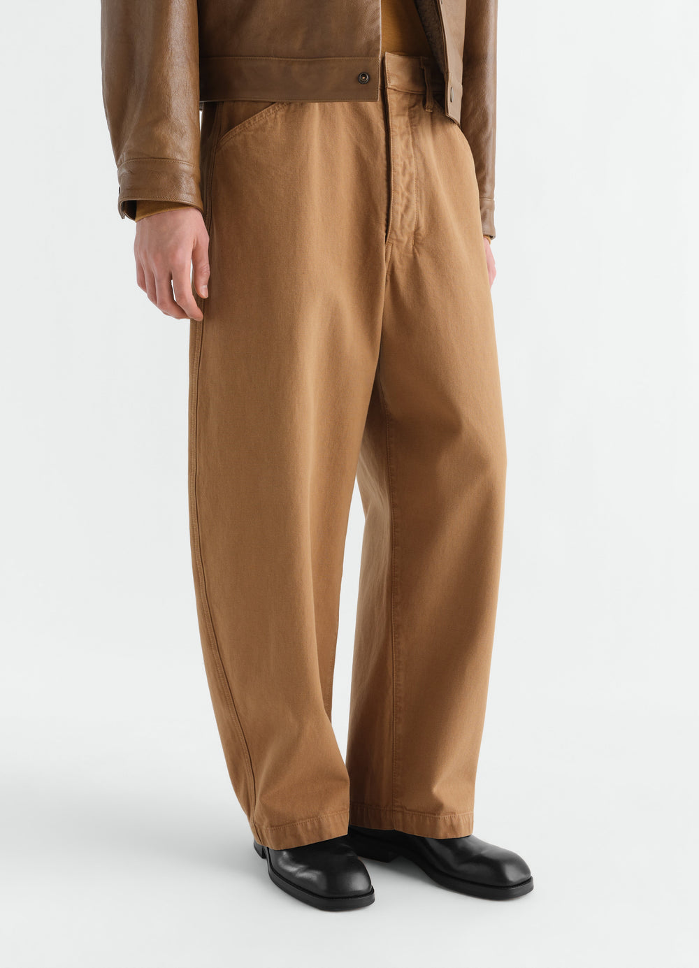 Formal loafers in shiny black leather LEMAIRE worn by a model with brown wide-leg trousers front view