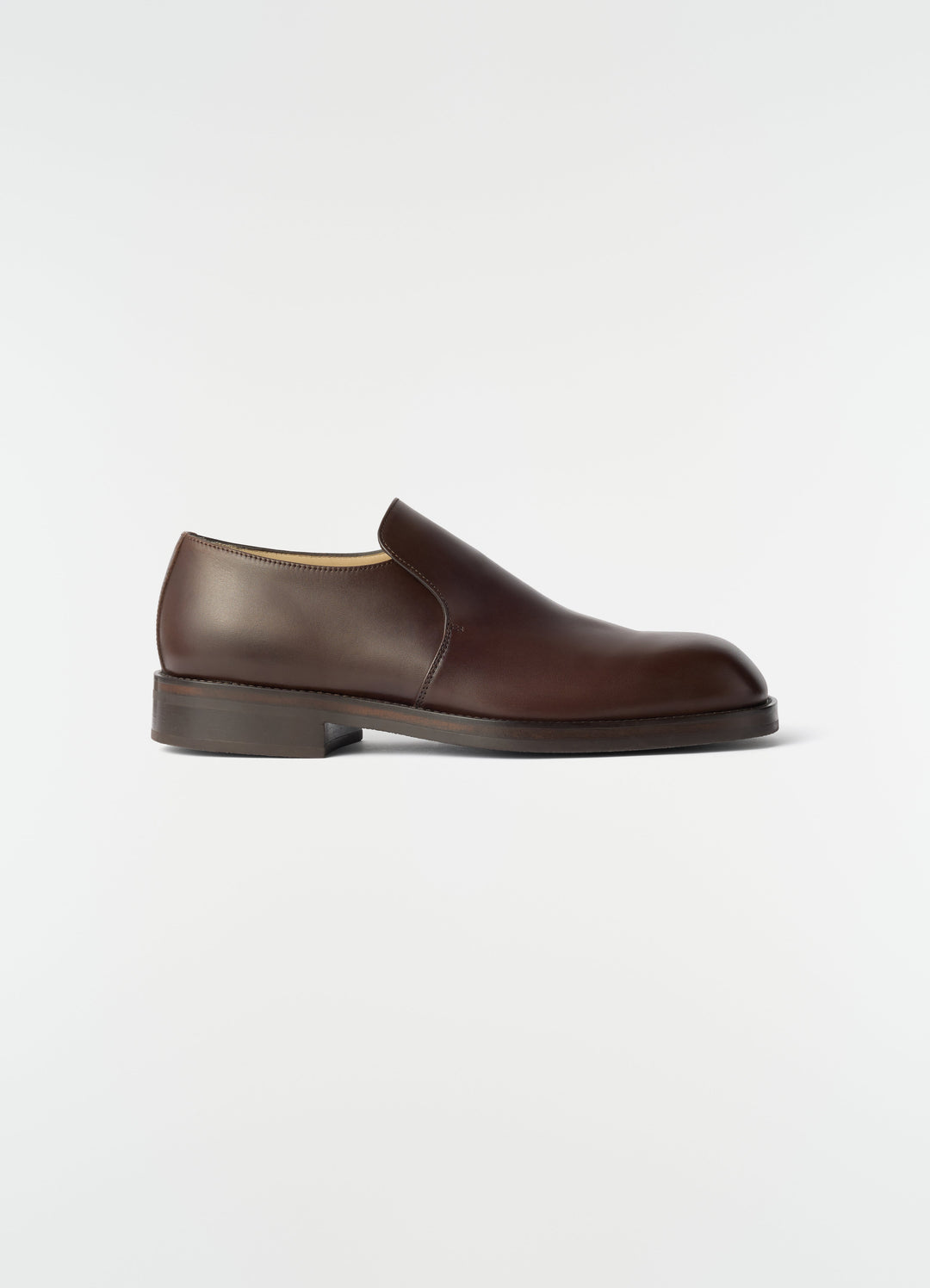 Formal brown shiny leather loafers LEMAIRE side view on plain white background