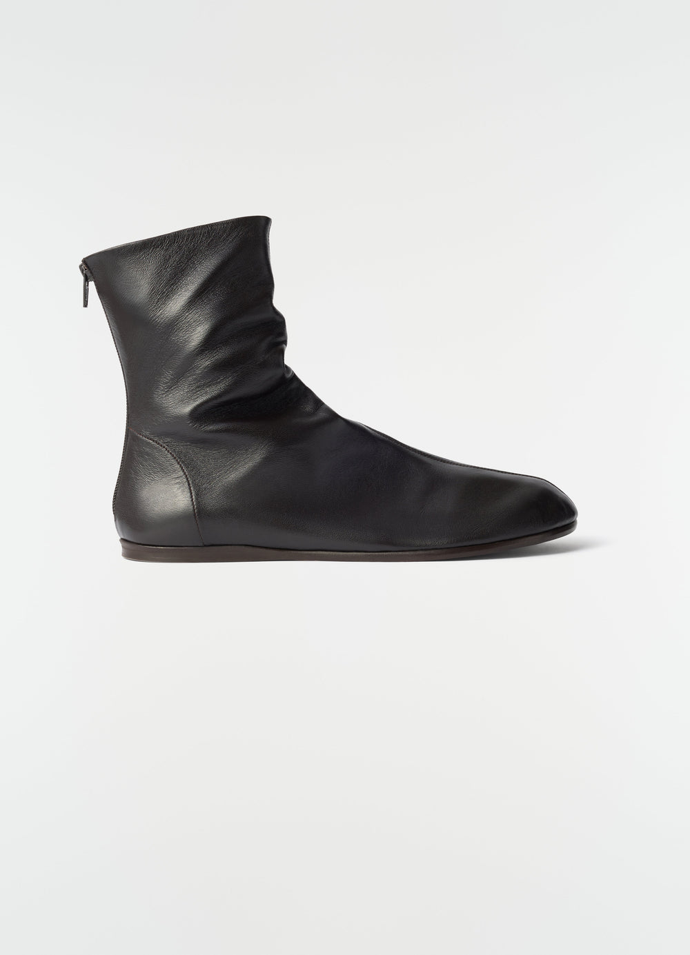 Sock ankle boots in shiny black nappa lambskin by LEMAIRE side view on plain white background