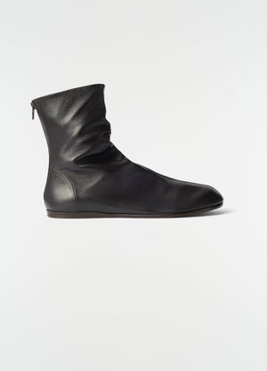 Sock ankle boots in shiny black nappa lambskin by lemaire side view on plain white background
