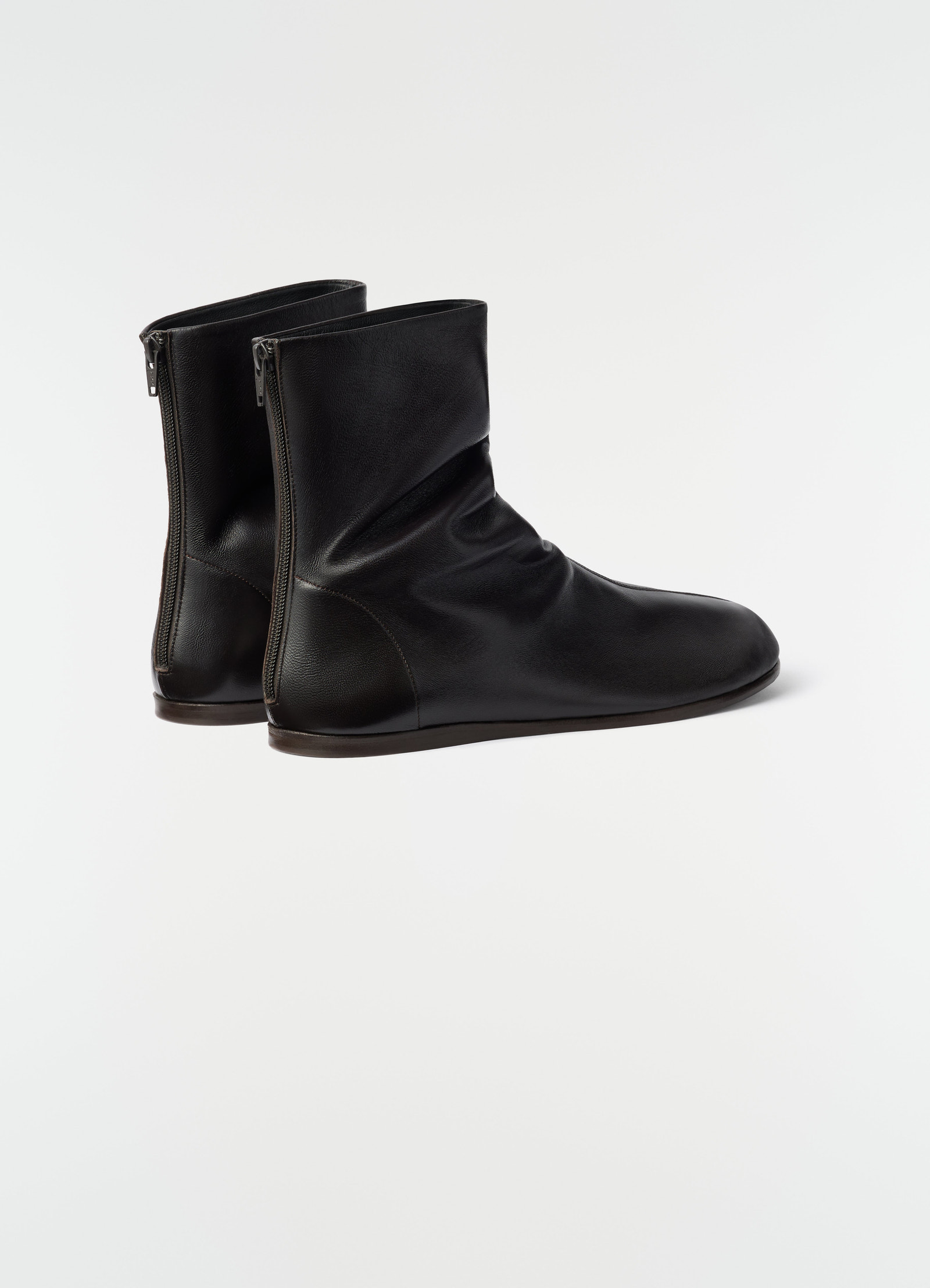 Sock ankle boots in black shiny nappa lambskin lemaire side view on plain white background