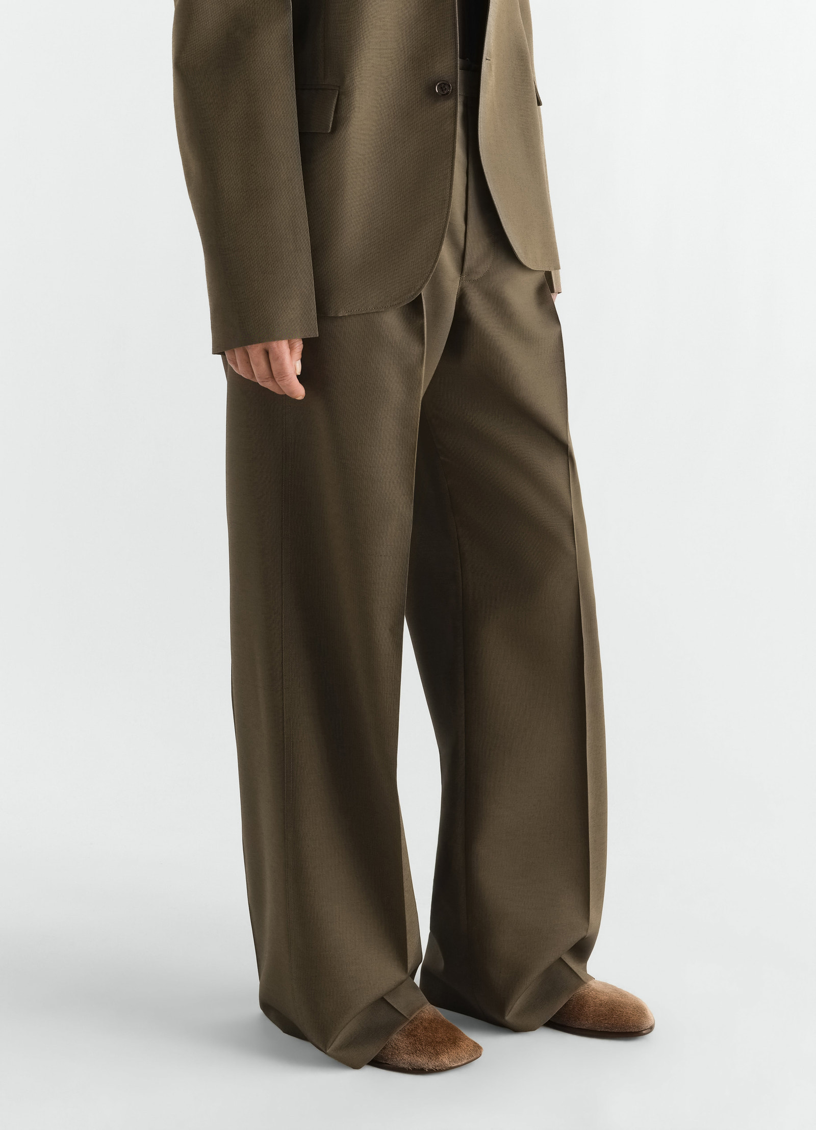 Glove slip-ons in natural pony-style leather lemaire worn by model with brown wide trousers front view