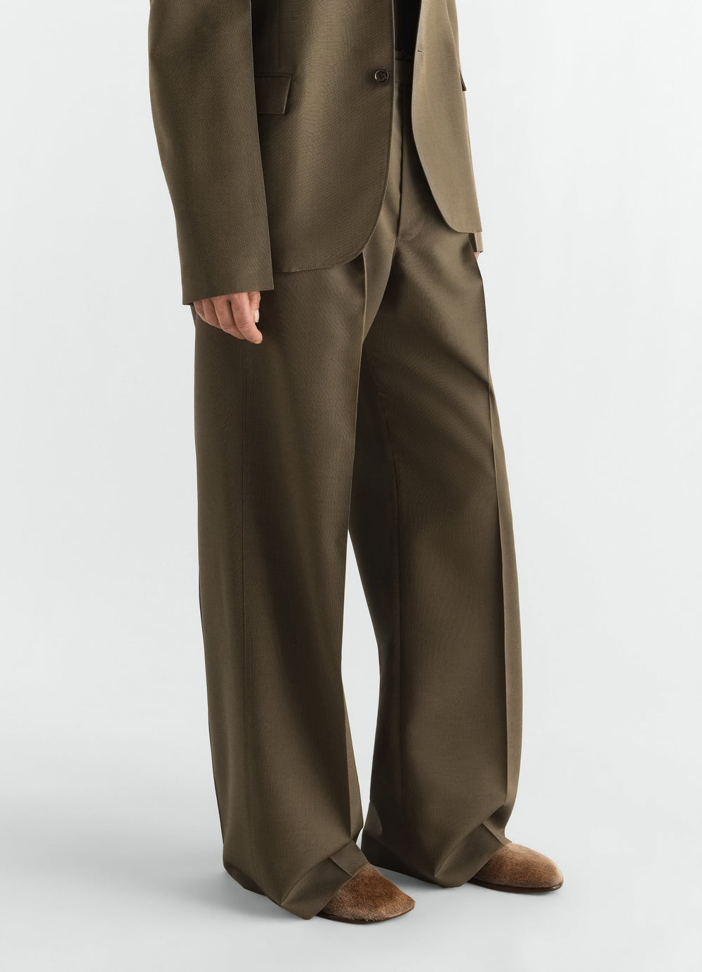 glove slip-ons in natural pony-style leather LEMAIRE worn by model with brown wide trousers front view