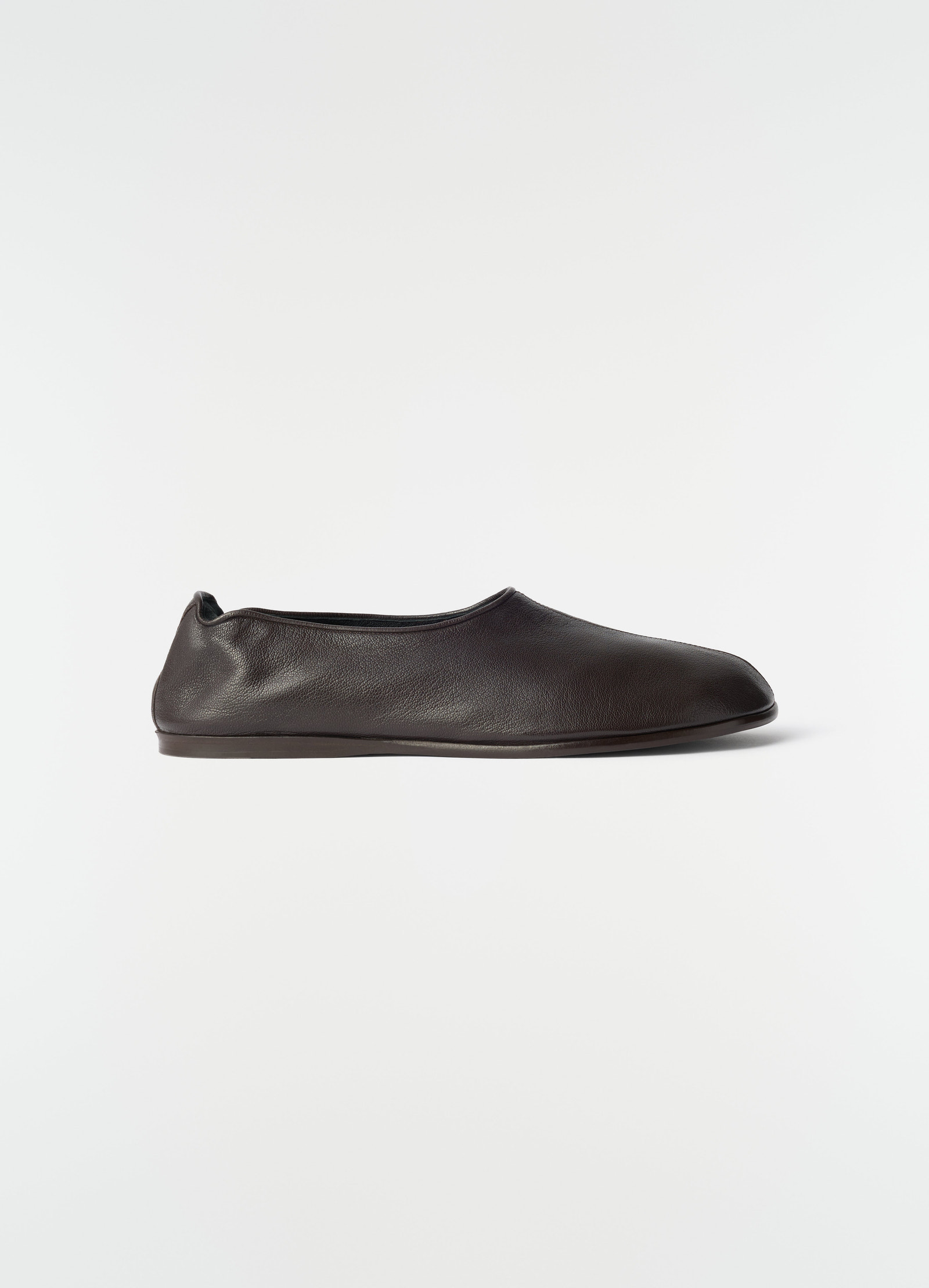 Sock slip-ons in dark brown goat leather by lemaire side view on plain white background