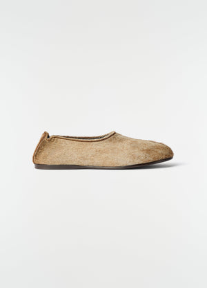 Sock slip-ons in natural pony-style leather with dark sole lemaire side view on white background
