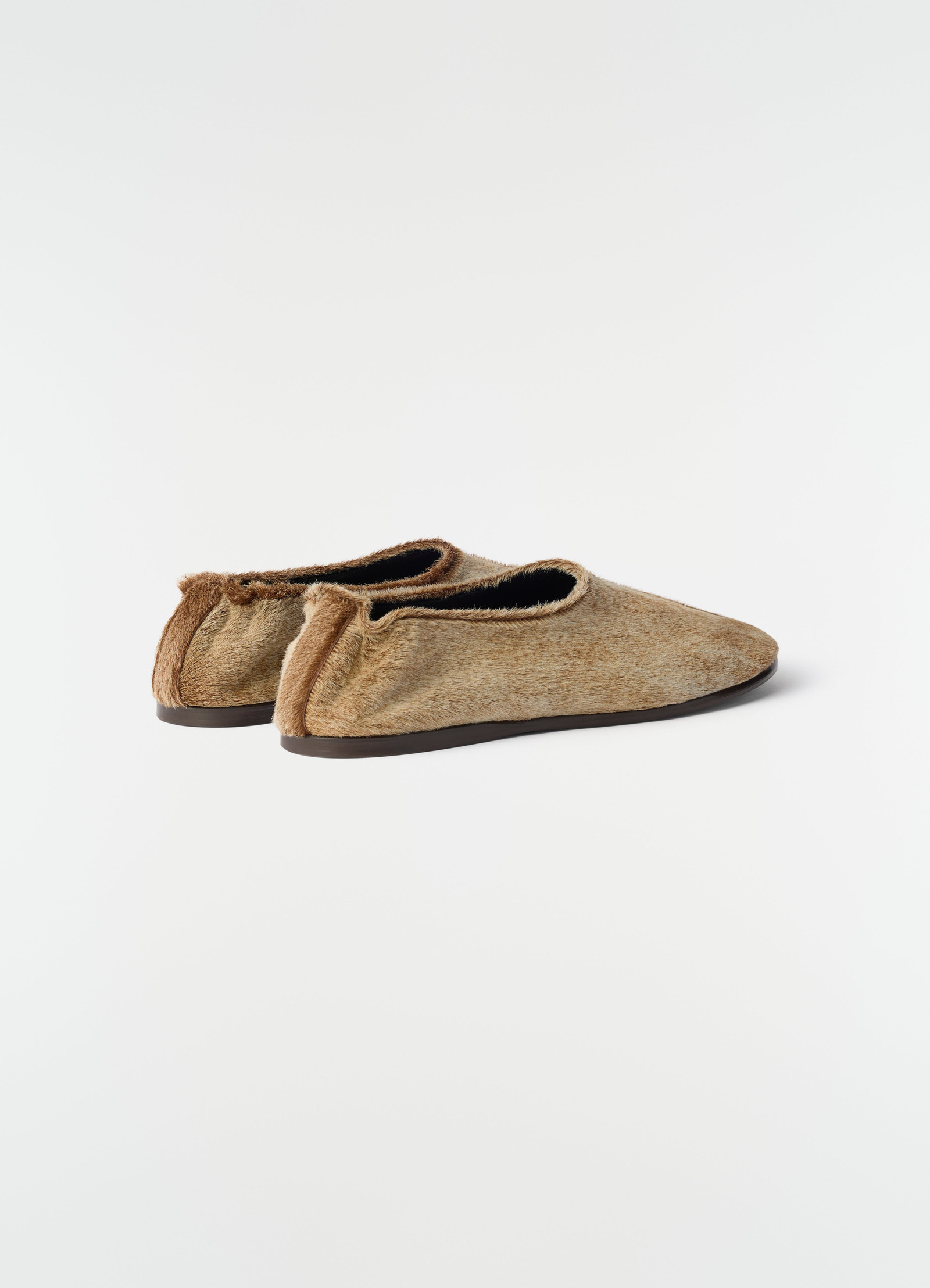 Sock slip-ons in natural pony-style leather with brown sole by lemaire side view on plain white background