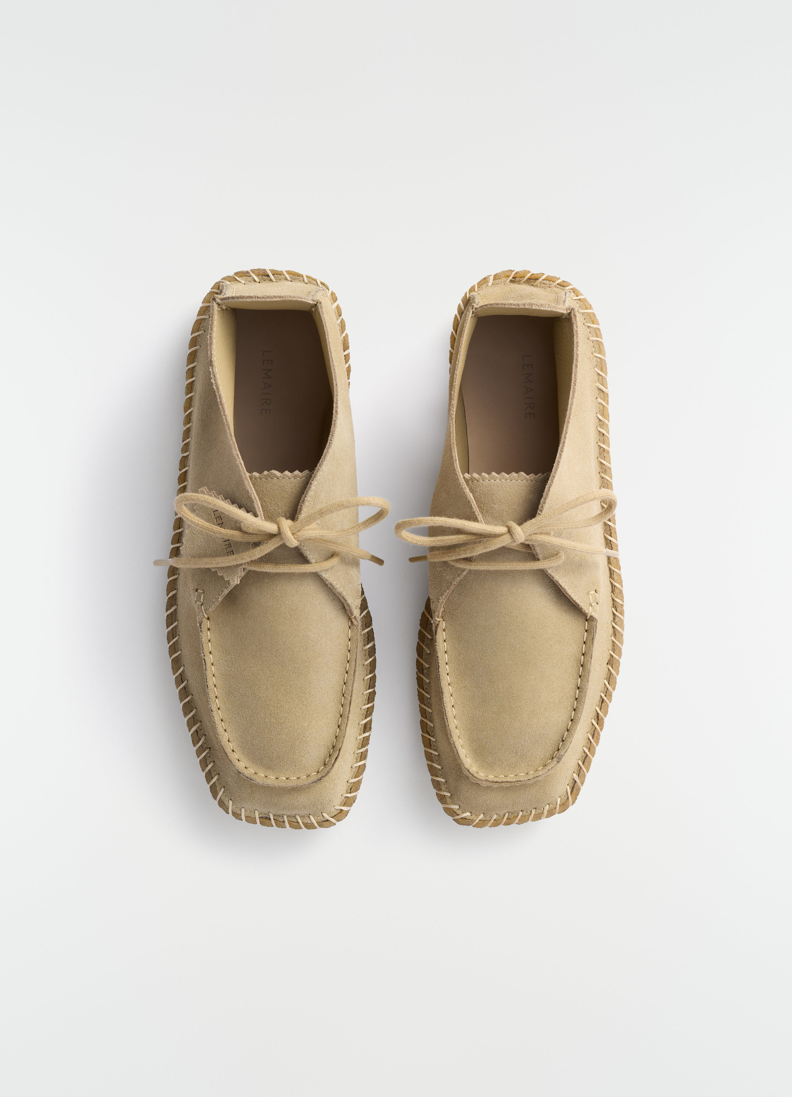 Desert moccasins in beige reversed suede leather by lemaire flat lay on white background with visible stitching detail