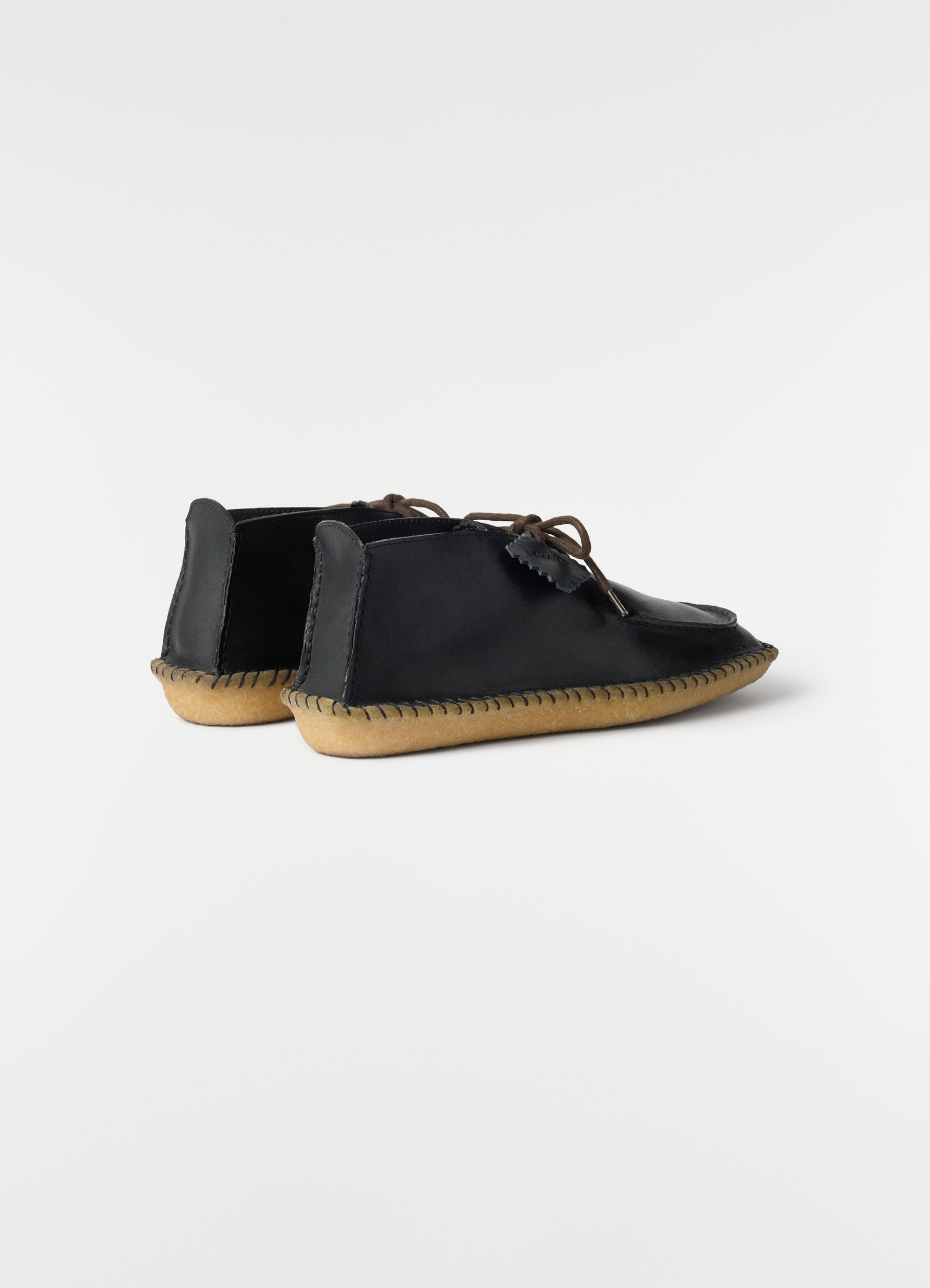 Desert moccasins black vegetable-tanned leather with crepe sole by lemaire side view on plain white background