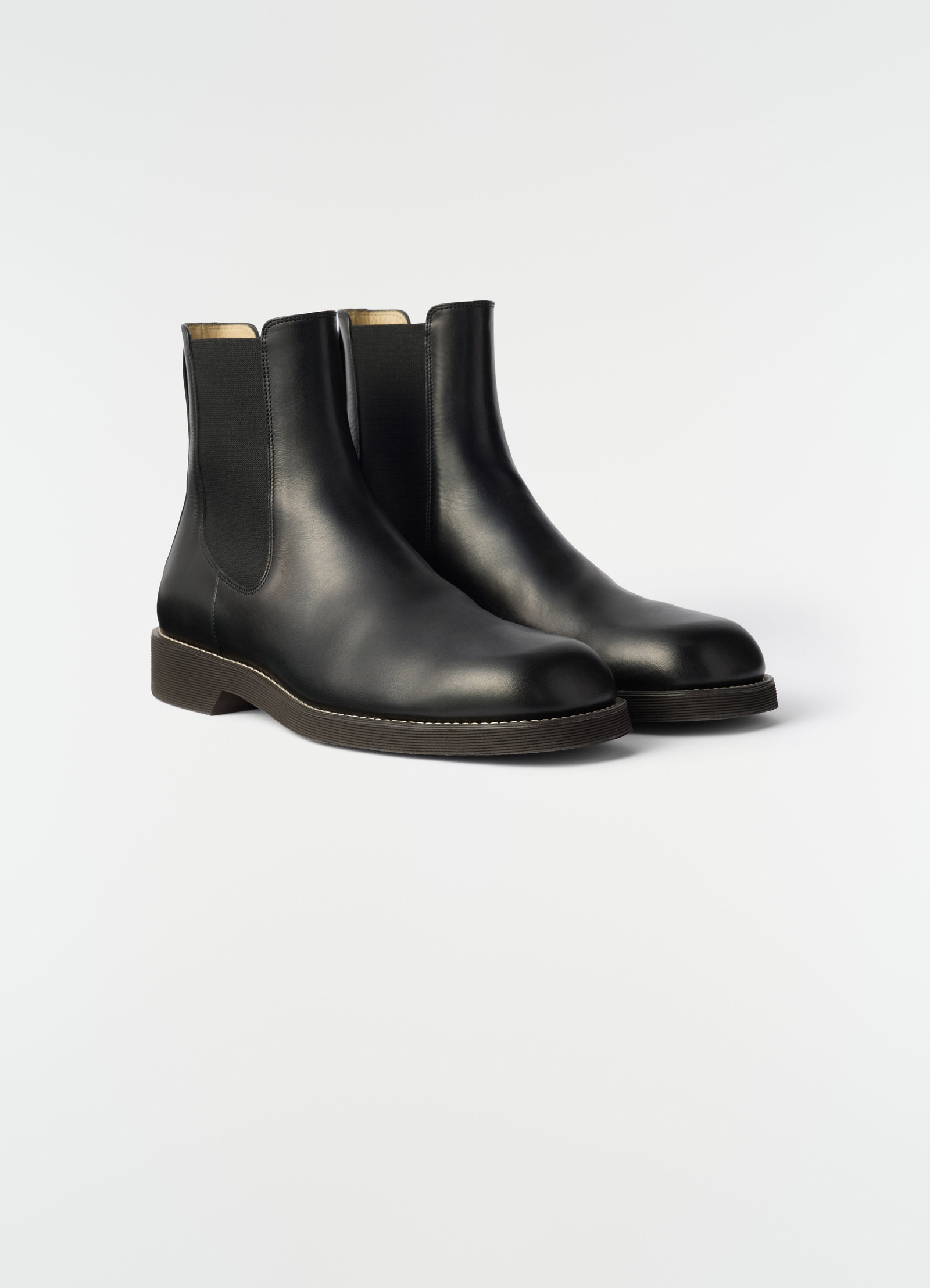 Chelsea ankle boots in black shiny vegetable-tanned leather with elastic sides by lemaire on plain white background