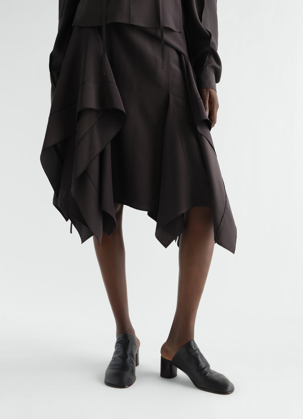55 MM GLOVE SLINGBACK-PUMPS AUS GESCHMEIDIGEM LAMMLEDER, in Schwarz, von einem Model getragen, Vorderansicht, Absatz sichtbar