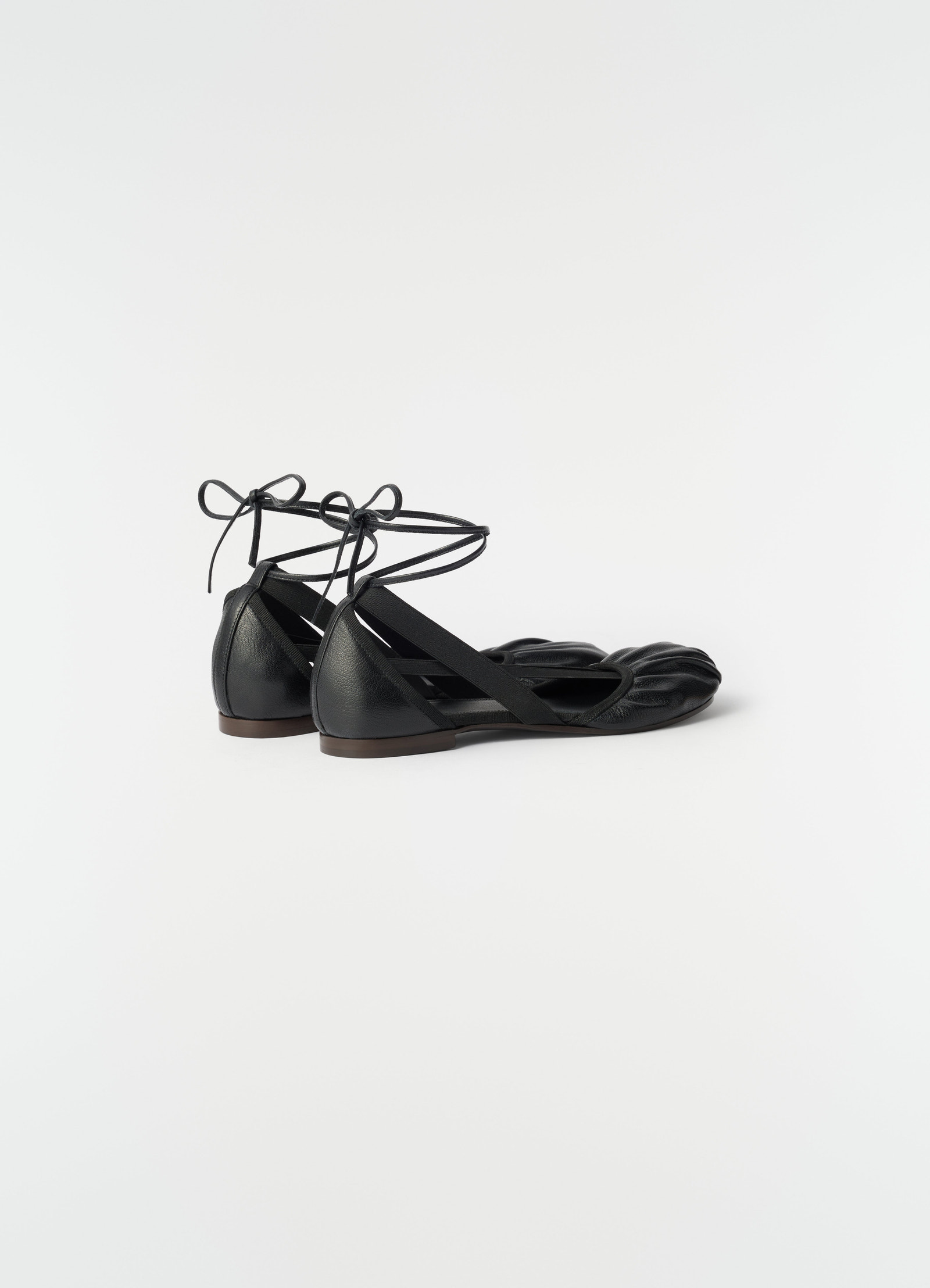 Flat pedille goat leather black ballerinas with ankle ties by lemaire side view worn by model
