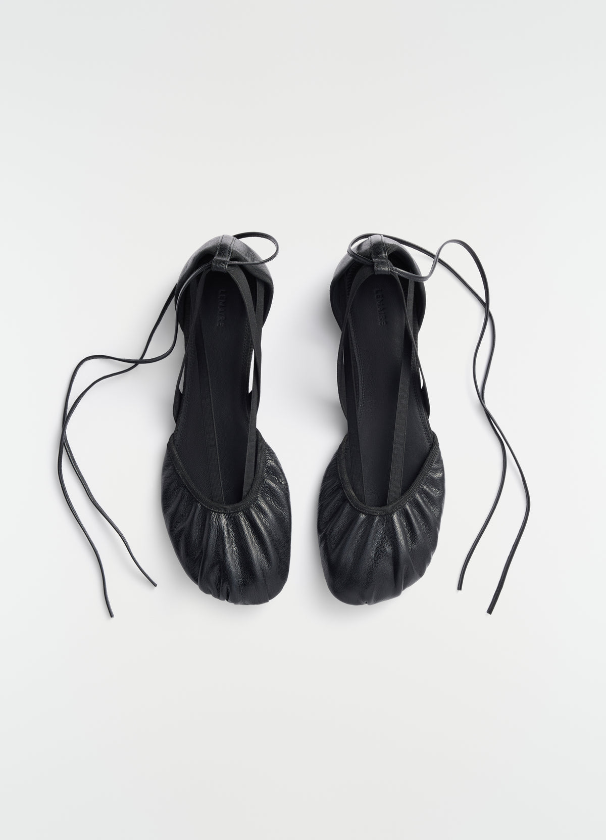 Flat Pedille ballerinas in black goat leather with ankle ties LEMAIRE side view on plain white background