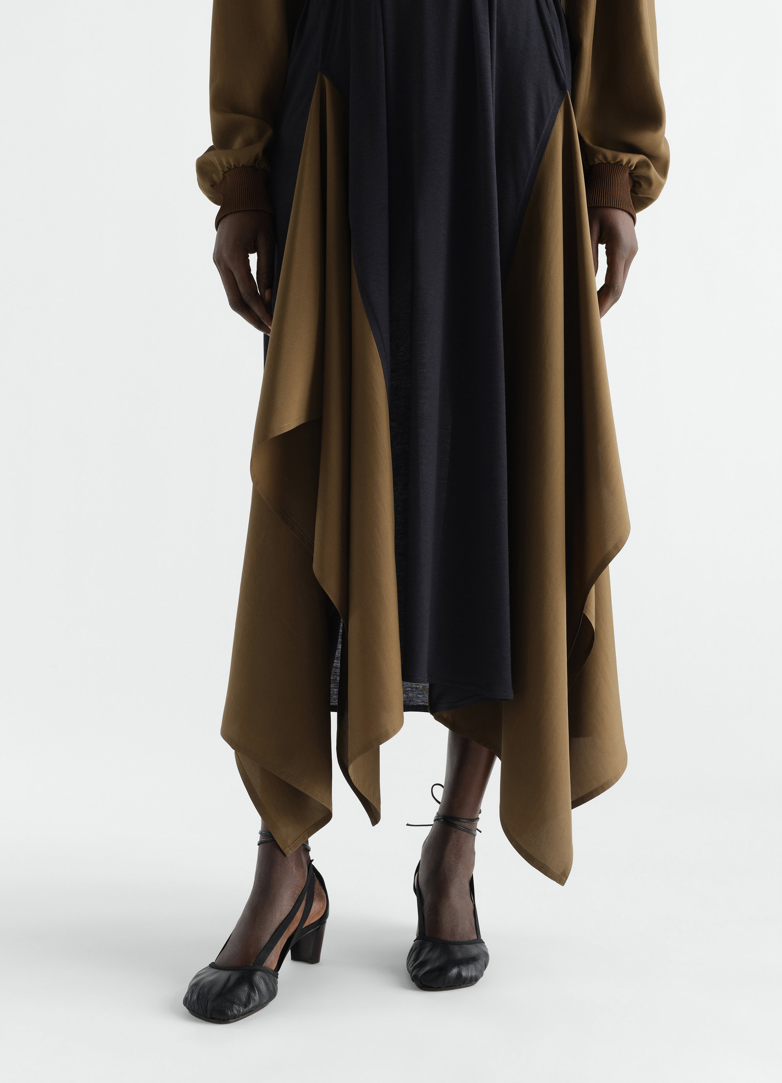 55 mm pedille black goat leather heeled ballerinas by lemaire worn by a model front view with brown dress