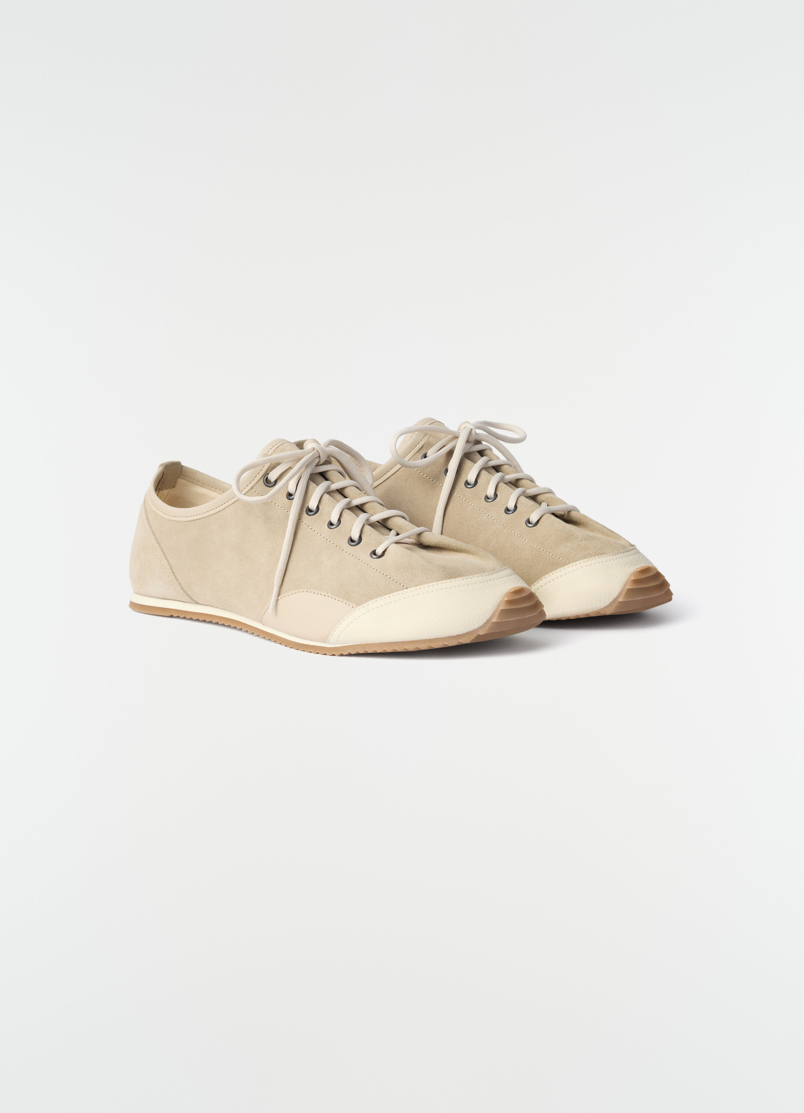 Gummy grips beige suede and leather sneakers by lemaire front angled view on white background