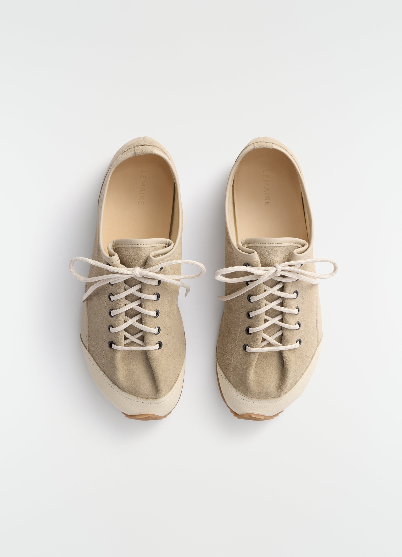 Gummy grips beige mixed leather sneakers by lemaire front view on plain white background