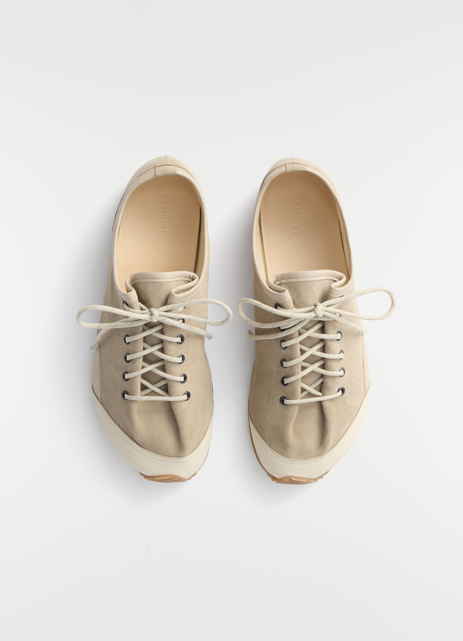 Gummy grips beige mixed leather sneakers by lemaire top view on plain white background