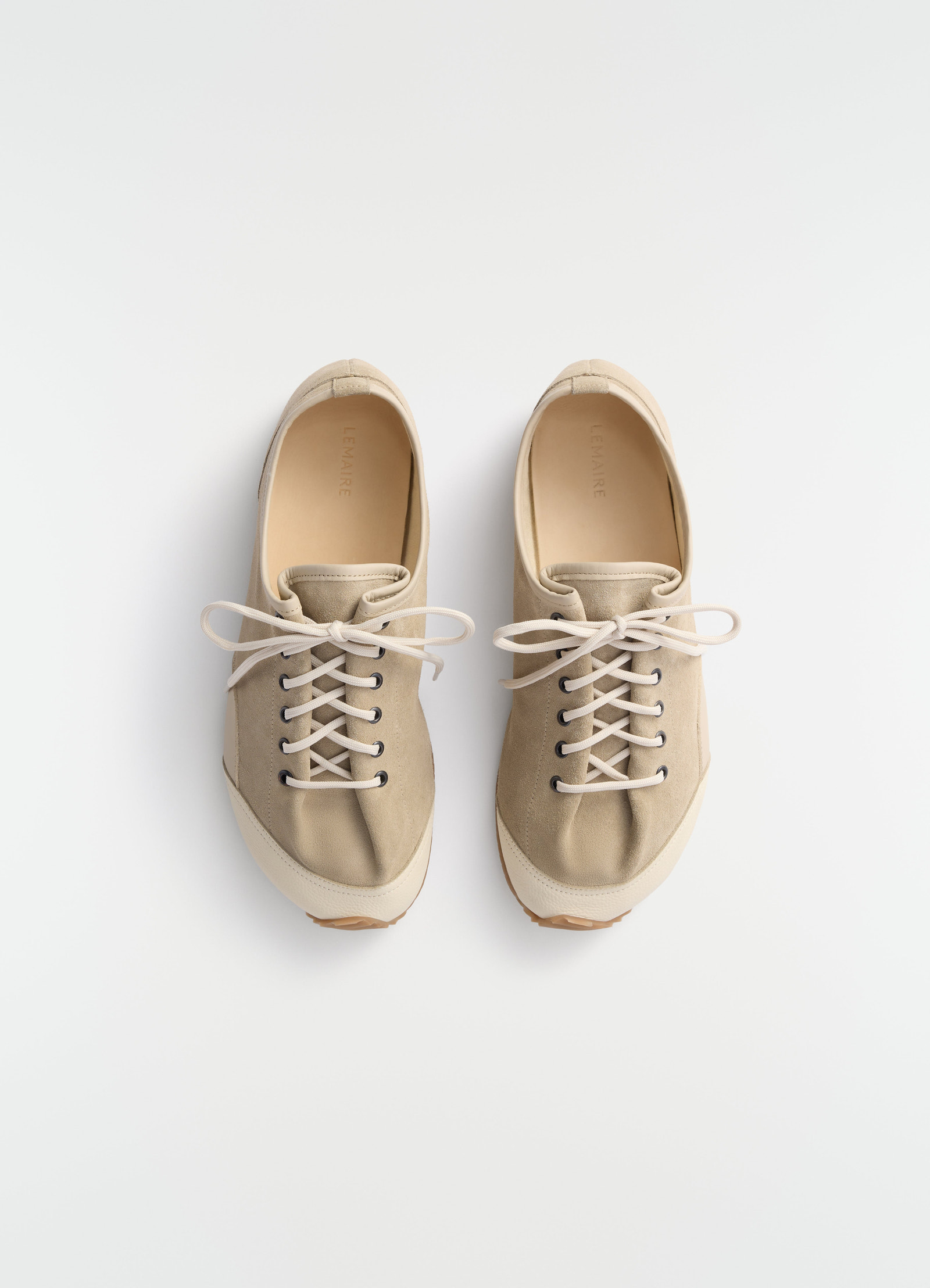 Gummy grips beige mixed leather sneakers by lemaire top view on plain white background