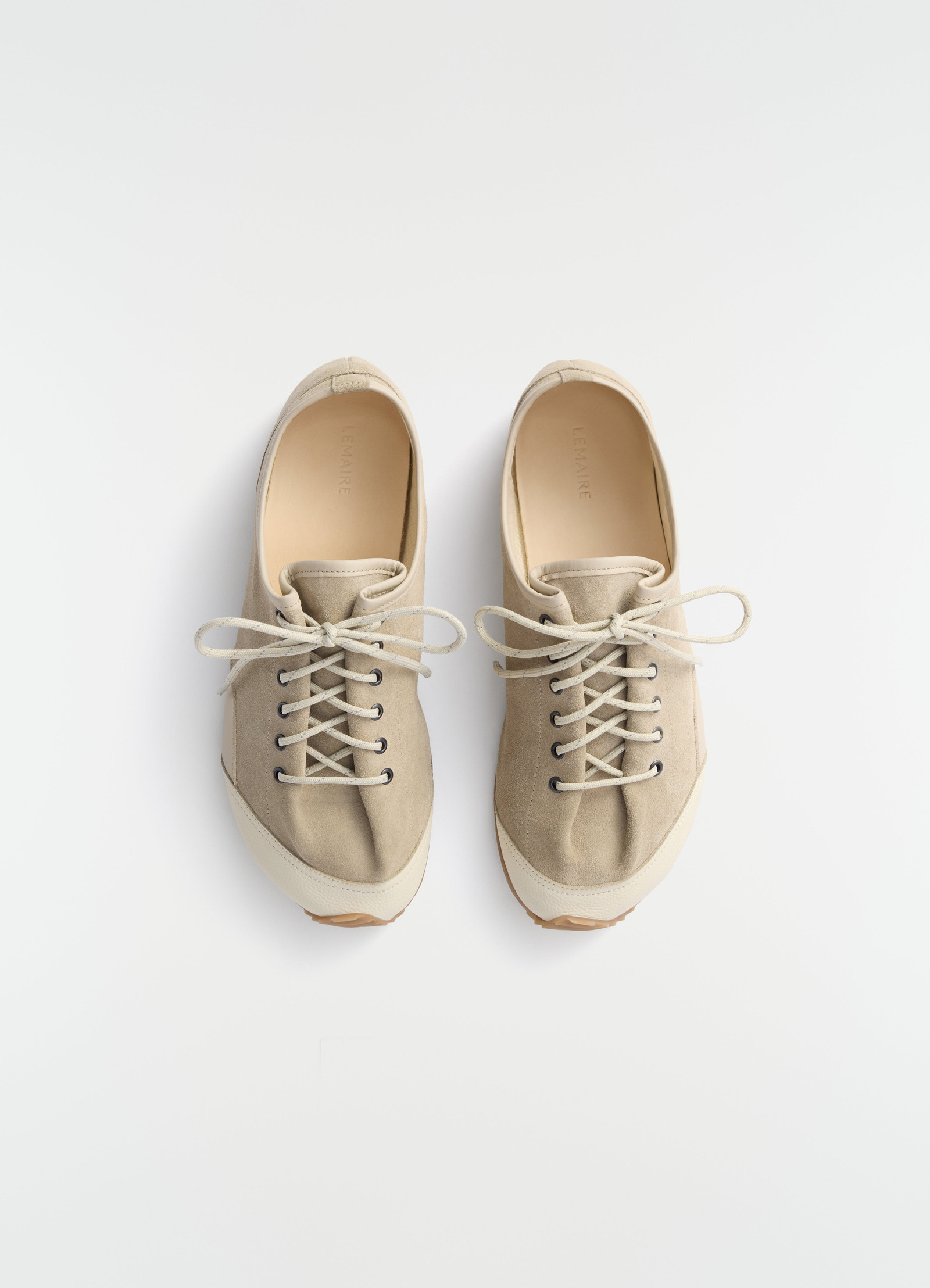 Gummy grips beige mixed leather sneakers by lemaire front view on white background