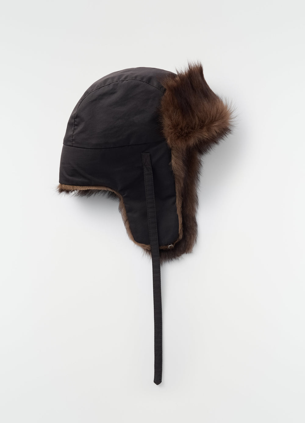 Black fabric and brown lambskin shearling fuzzy chapka hat by LEMAIRE side view on plain white background