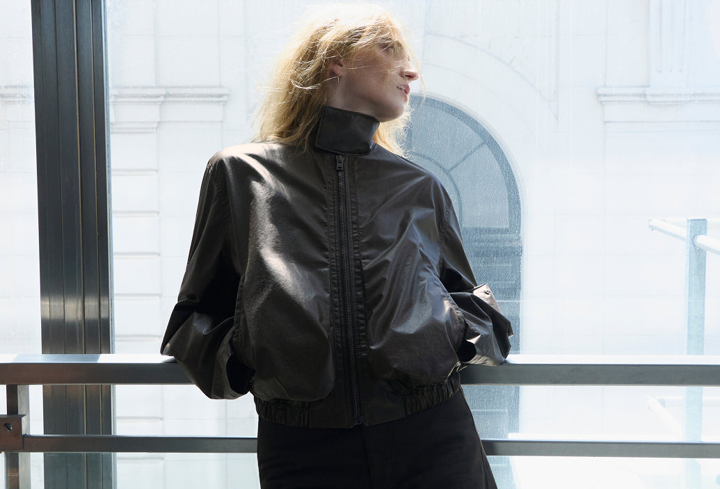 Twisted belted brown heavy broken twill pants by LEMAIRE worn by two models front and side view main look
