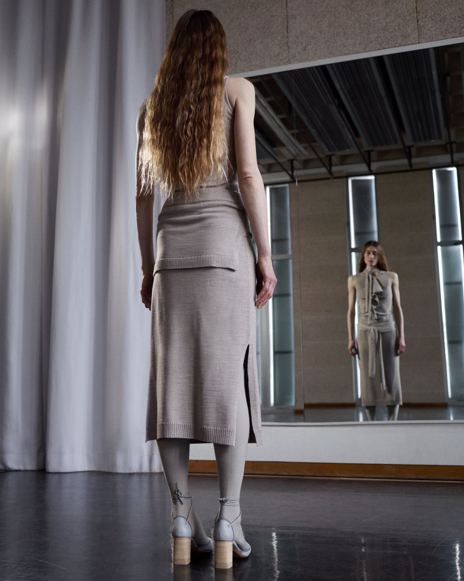 Beige knit dress in beige knit fabric, model shot, back view fitted with side slit