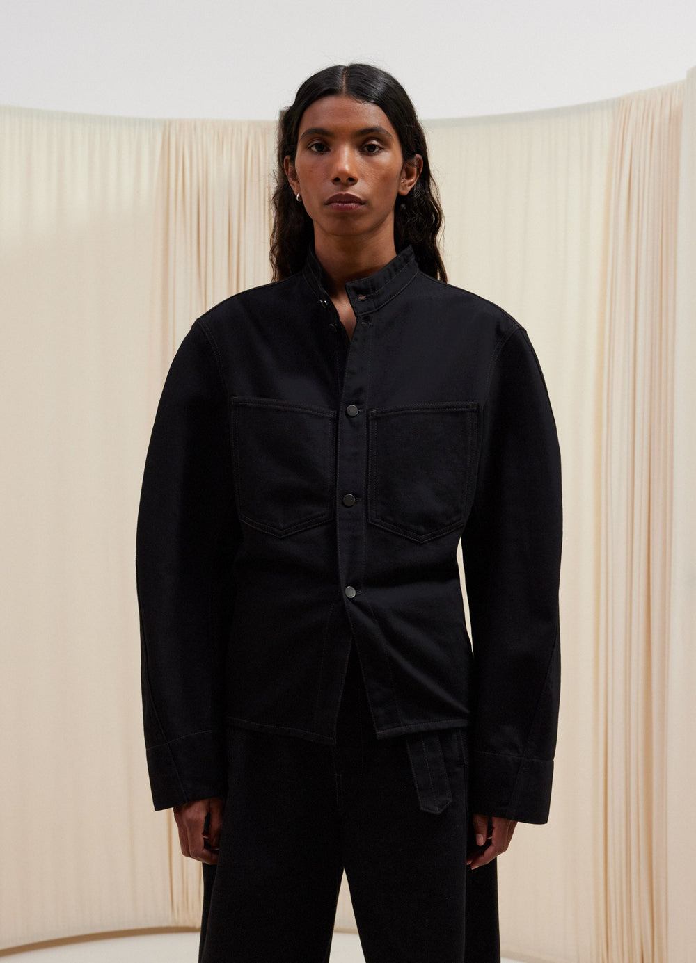 Lemaire Curved Sleeve Jacket in Raw Black Cotton Denim, model shot, Front view Curved sleeves, fitted