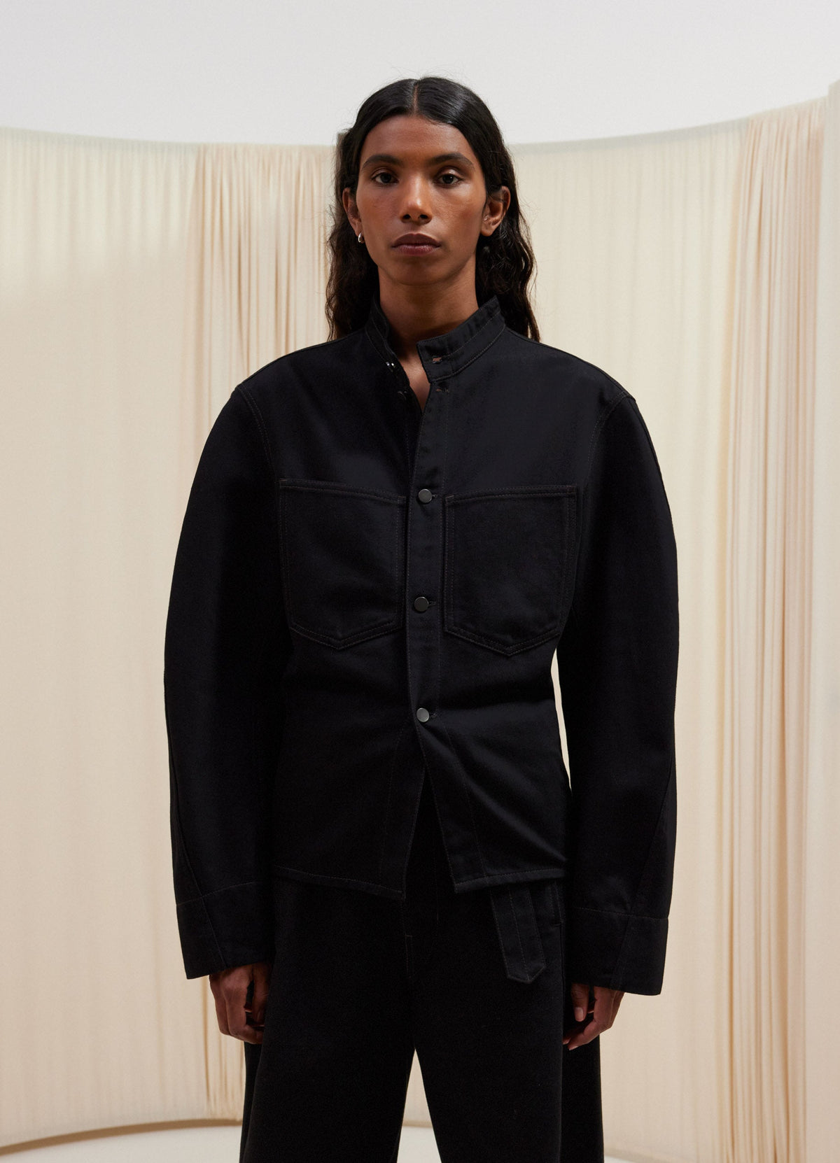 Lemaire Curved Sleeve Jacket in Raw Black Cotton Denim, model shot, Front view Curved sleeves, fitted