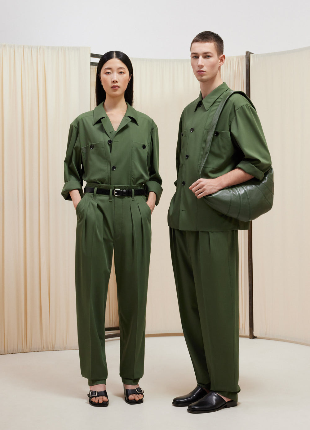 Lemaire Tailored Pleated Pants in Green Virgin Wool, model shot, Front view Tapered leg with pleats