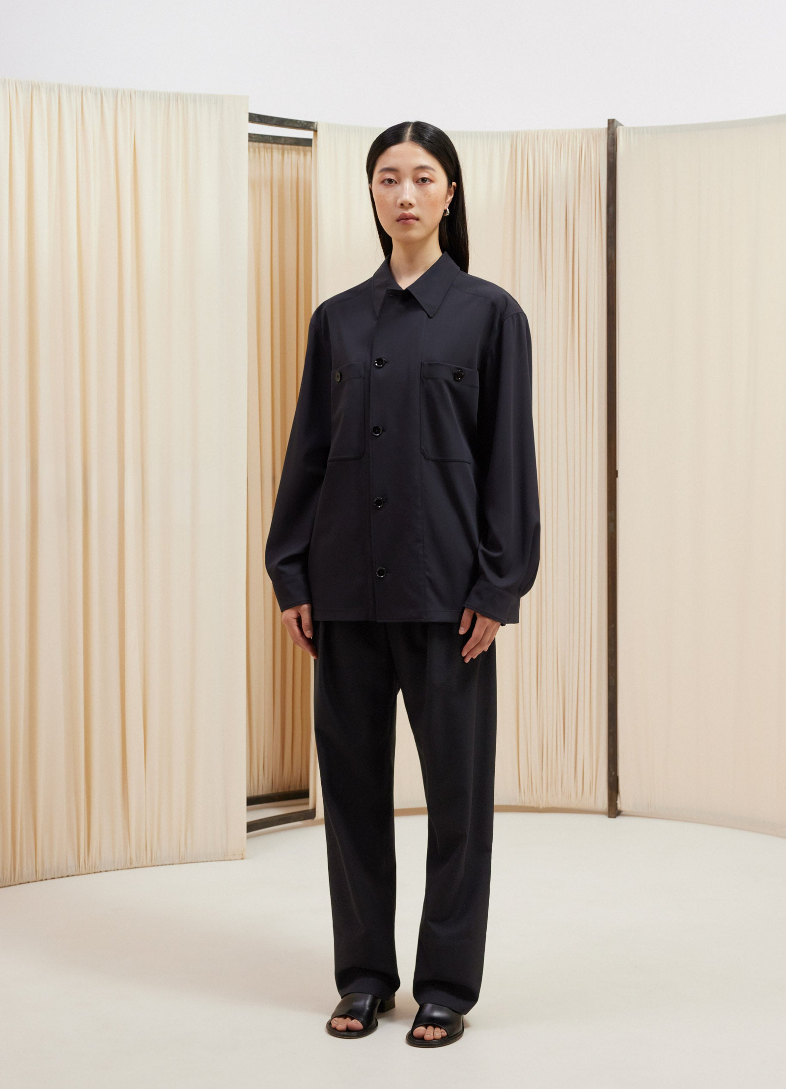 Lemaire soft military overshirt in deep navy virgin wool, model shot, three-quarter view dropped shoulders