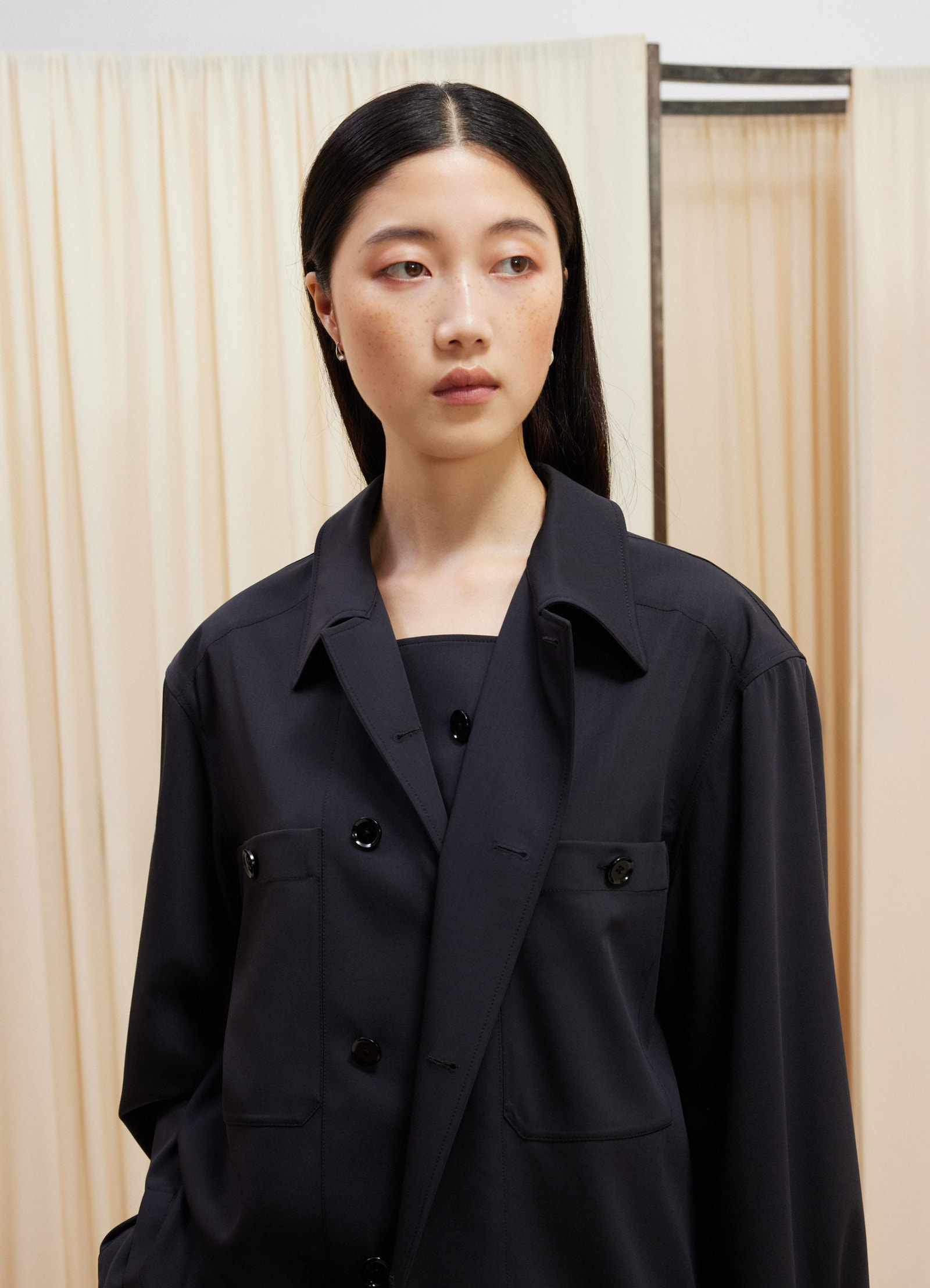 Lemaire soft military overshirt in deep navy virgin wool, model shot, close-up view buttoned pockets detail
