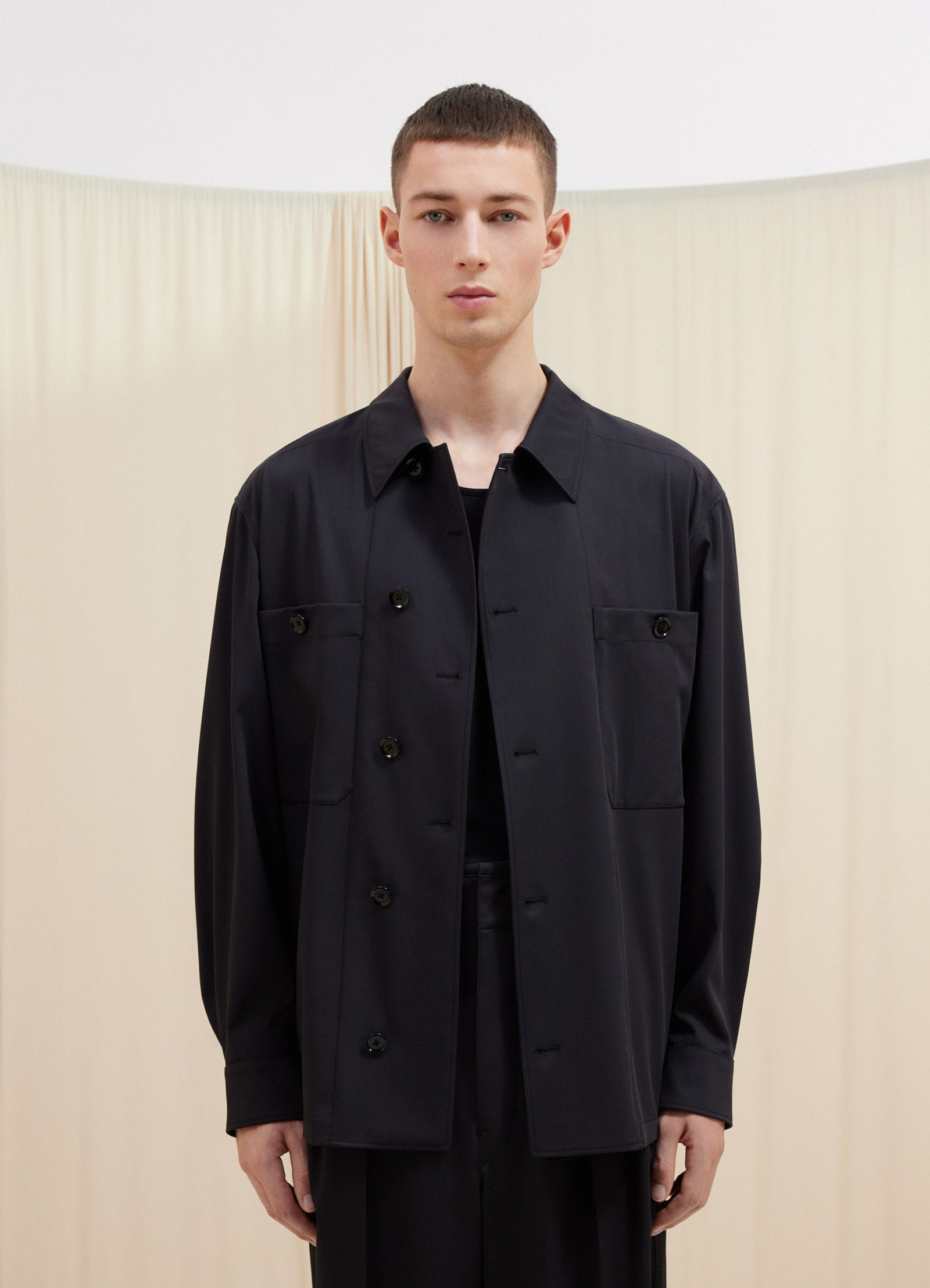 Lemaire soft military overshirt in deep navy virgin wool, model shot, front upper body view relaxed fit with plain cuffs