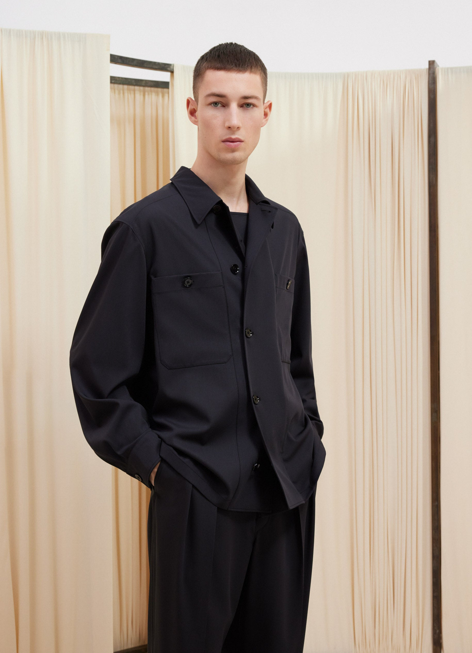 Lemaire soft military overshirt in deep navy virgin wool, model shot, side upper body view relaxed fit with open collar