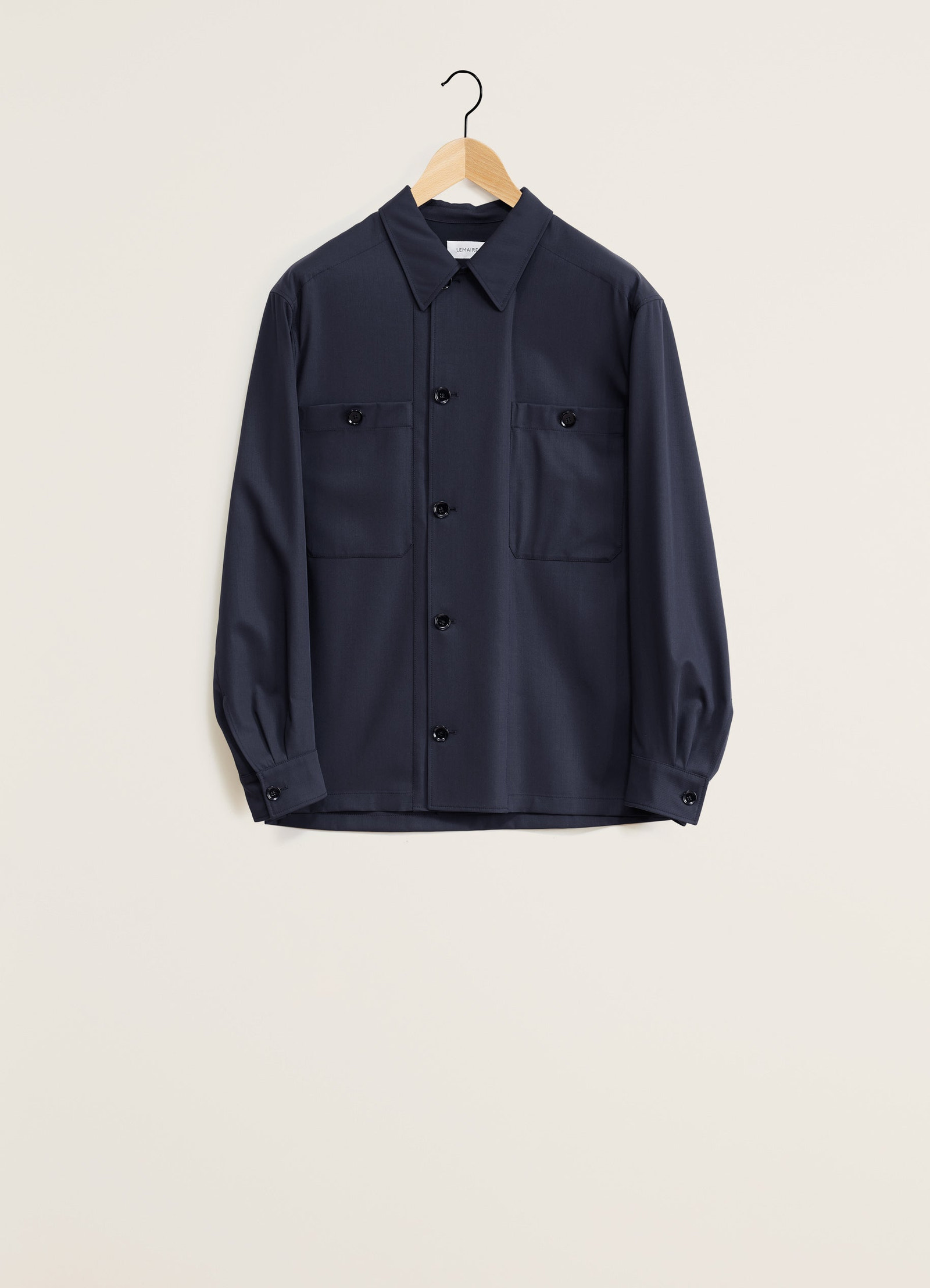 Lemaire soft military overshirt in deep navy virgin wool, product shot, front hanging view button front with two pockets