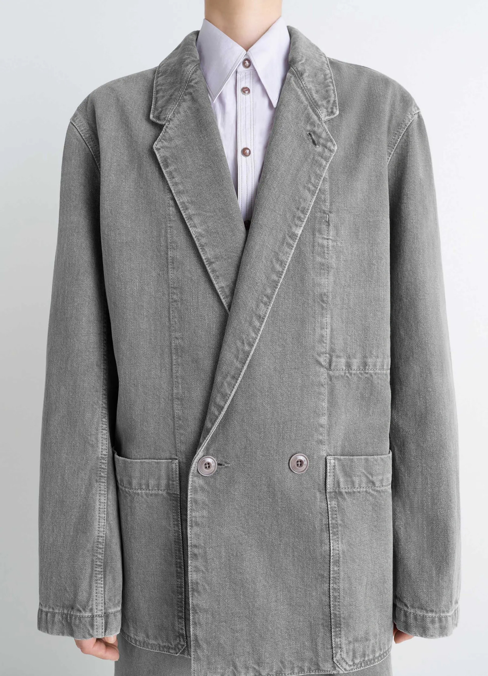 Lemaire workwear blazer in garment dyed snow denim, model shot, detail shot double breasted design