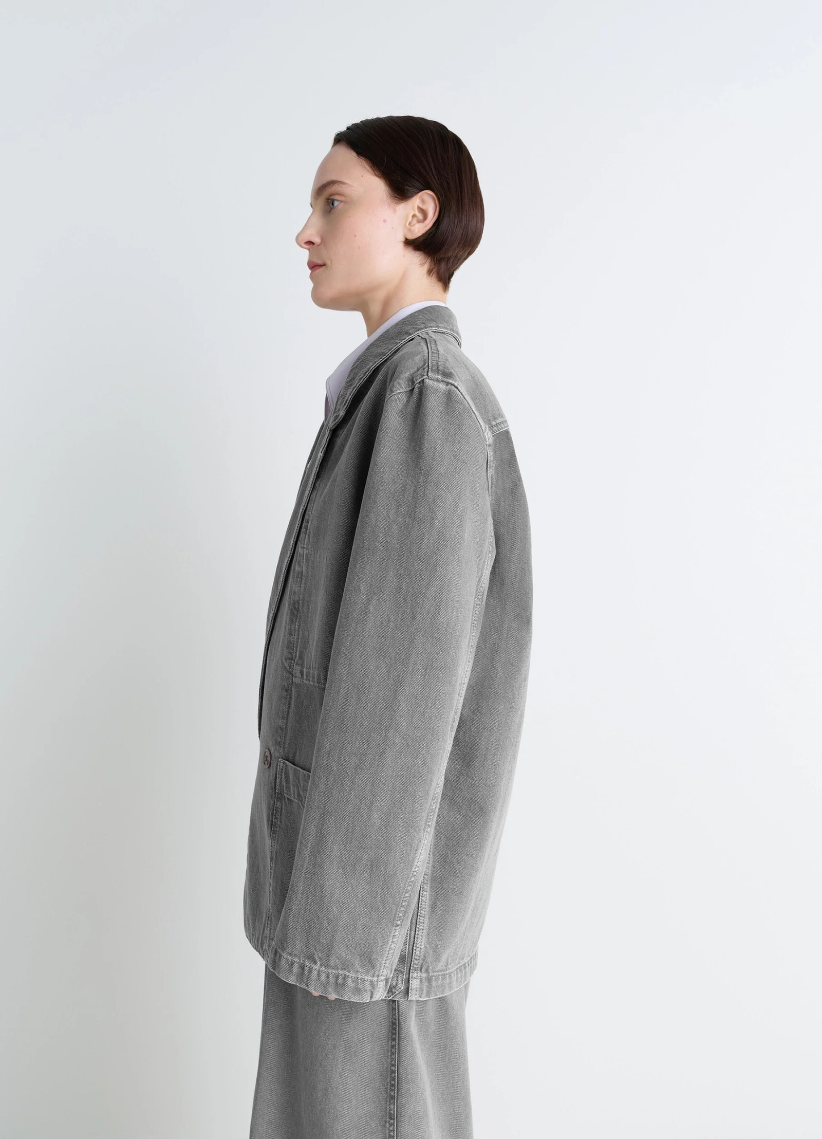 Lemaire workwear blazer in garment dyed snow denim, model shot, side profile view oversized cut