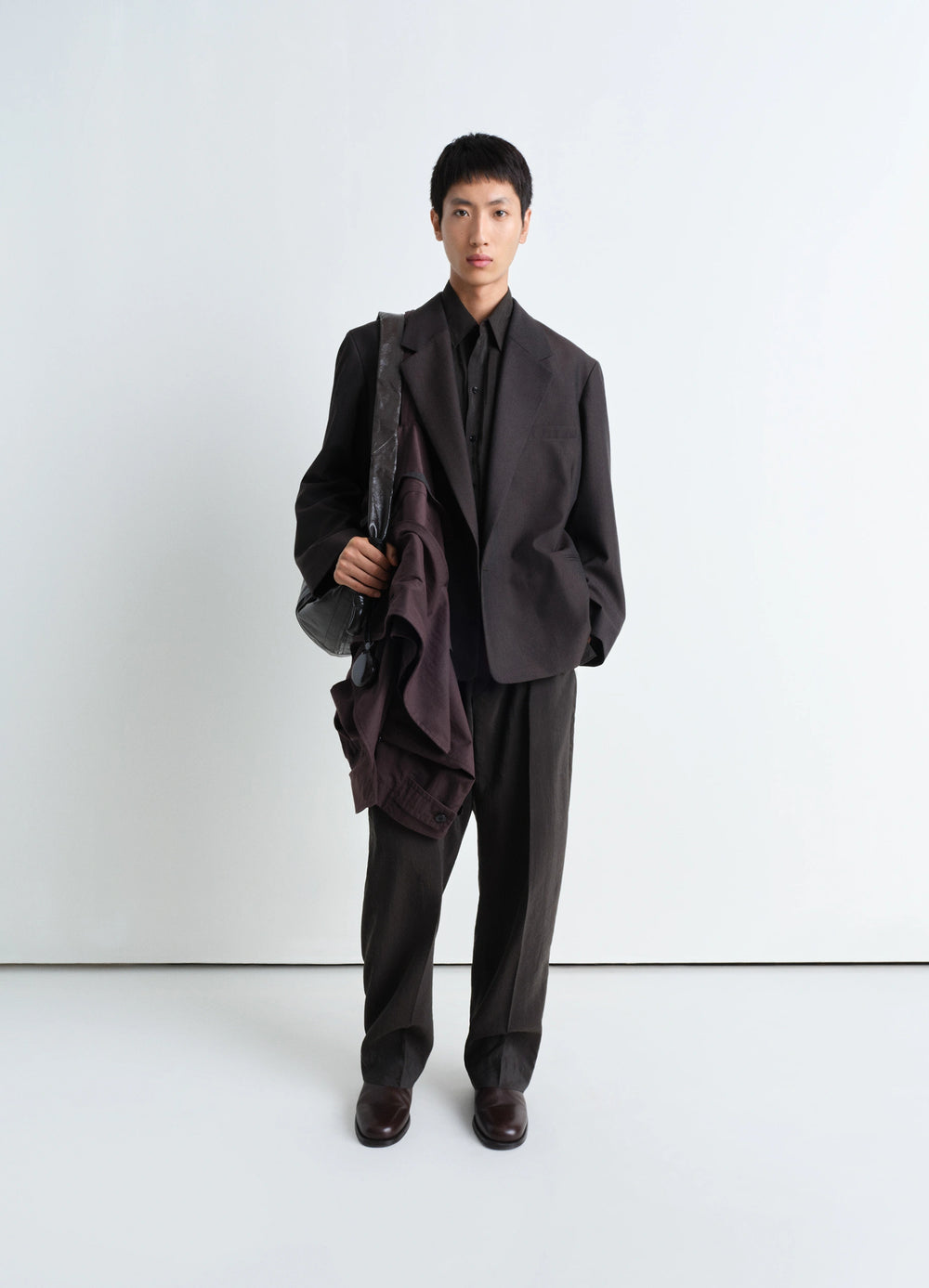 Lemaire Soft Double Breasted Jacket in Tropical Poly-Wool Mélange Twill, model shot, three-quarter view relaxed fit, straight