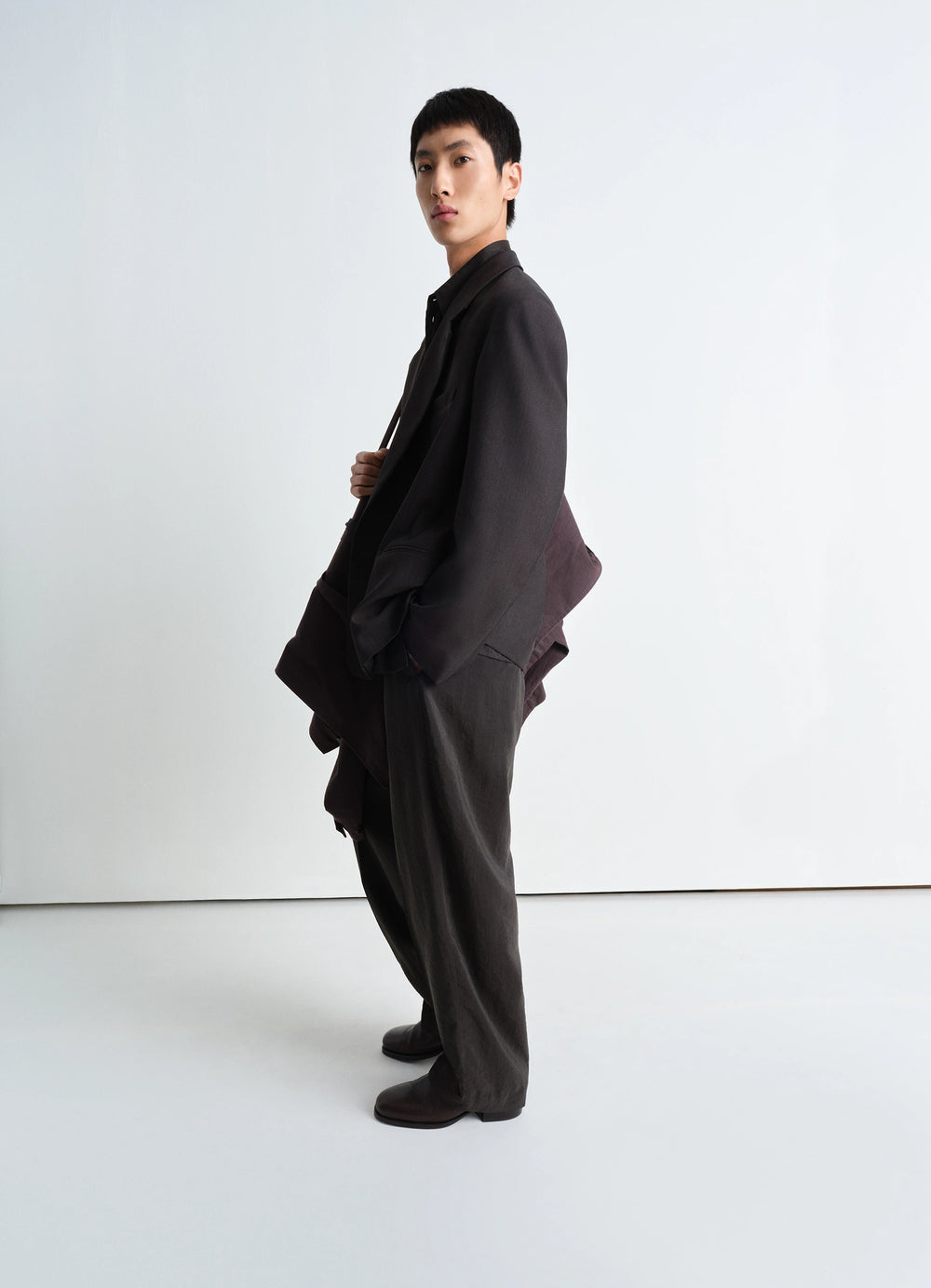 Lemaire Soft Double Breasted Jacket in Tropical Poly-Wool Mélange Twill, model shot, side profile draped silhouette