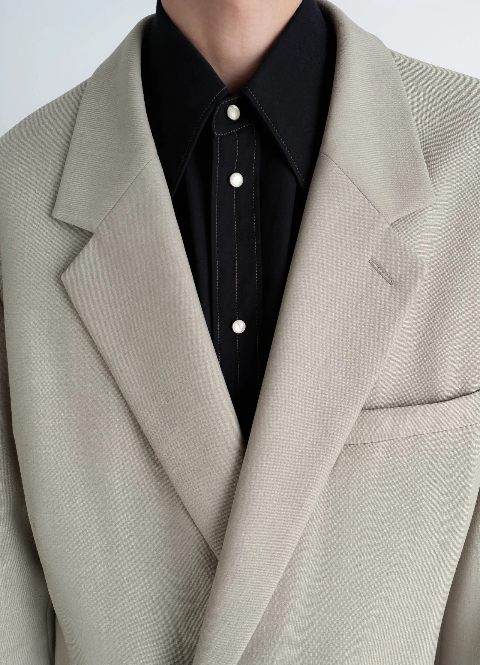 Soft double breasted jacket in mottled tropical wool-blend, model shot, close-up detail shot notched lapel