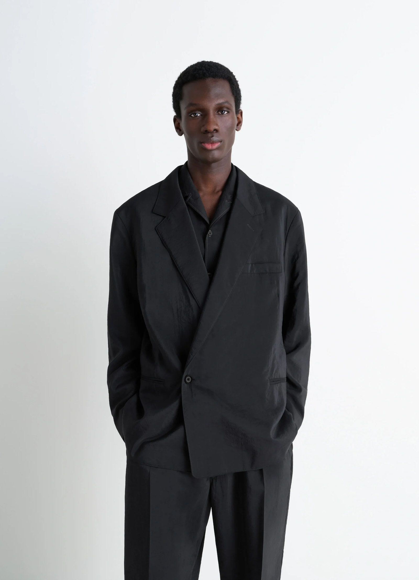 Lemaire soft double breasted jacket in black dry silk blend, model shot, front view classic tailored fit