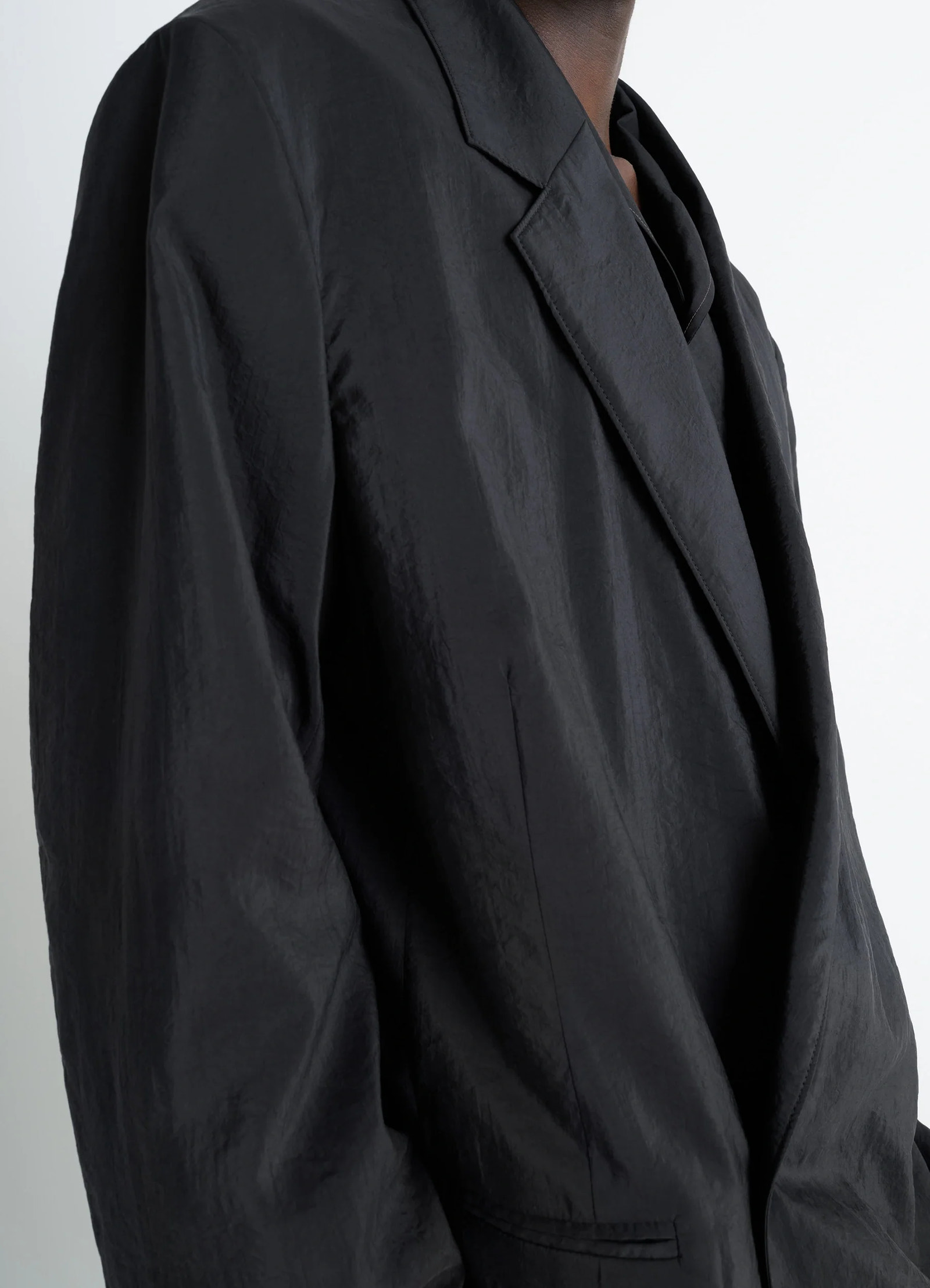 Lemaire soft double breasted jacket in black dry silk blend, model shot, close-up detail shot soft crinkled texture