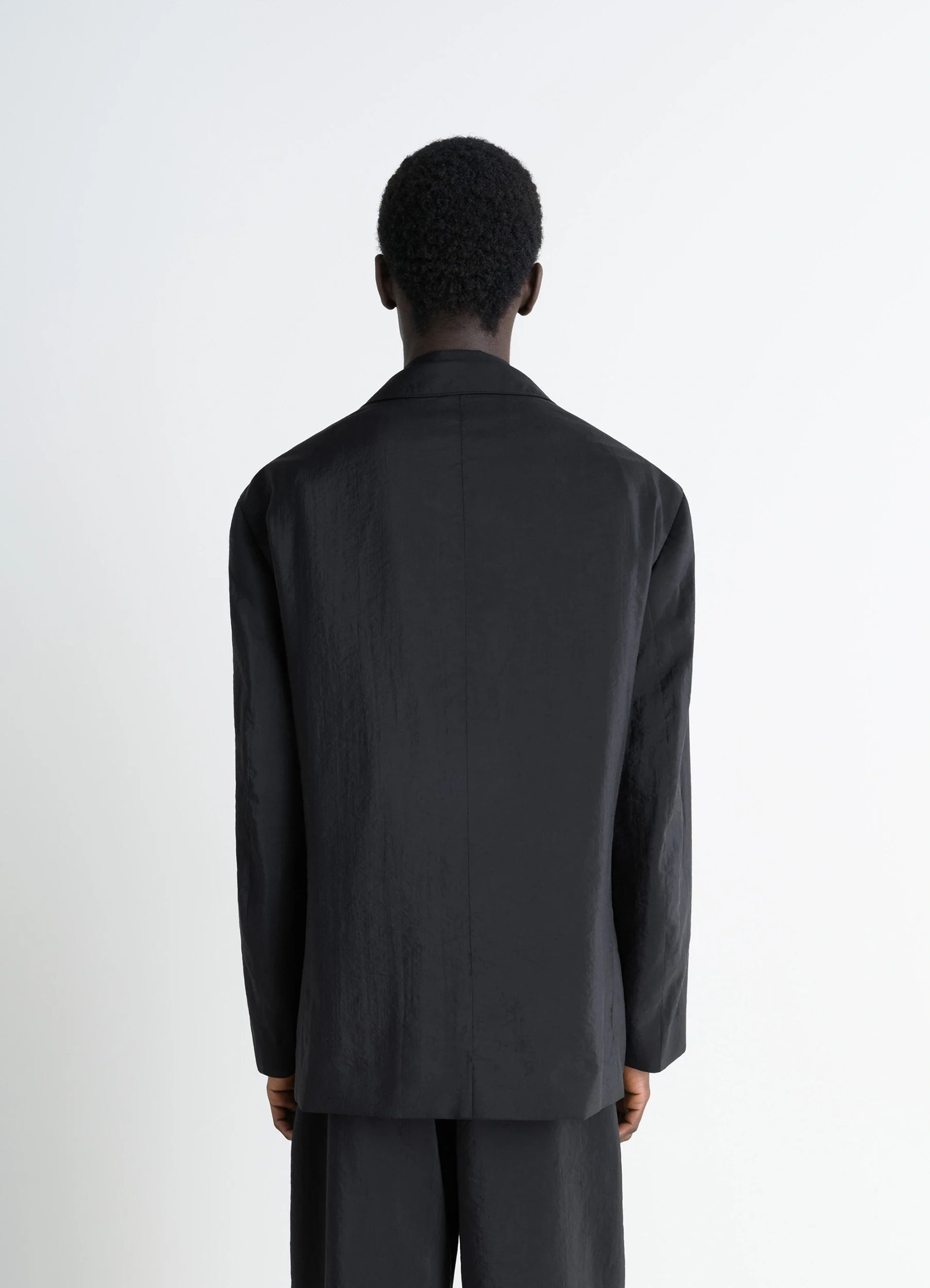 Lemaire soft double breasted jacket in black dry silk blend, model shot, back view seamless back detail