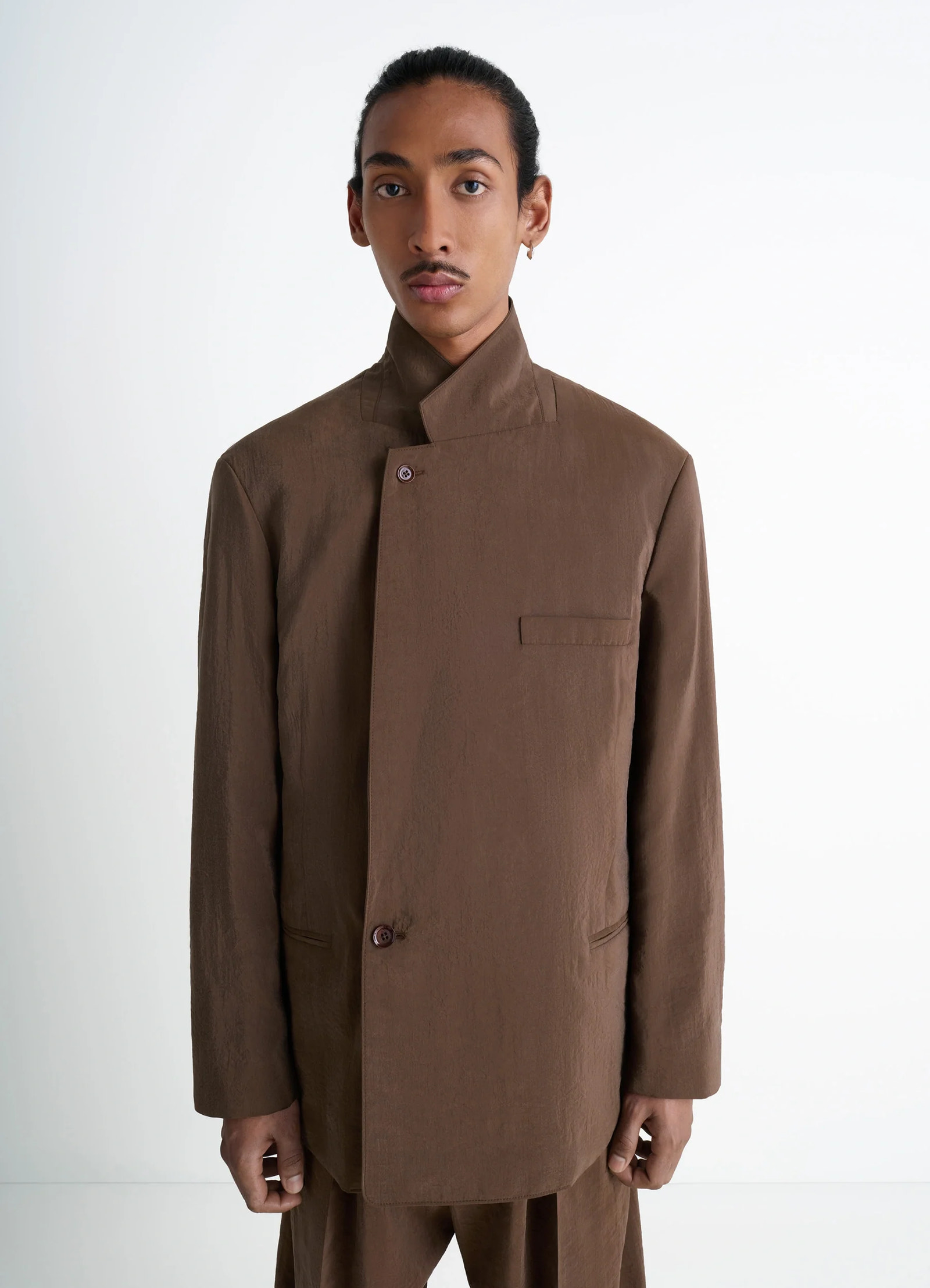 Lemaire soft double-breasted jacket in heather brown dry silk blend, model shot, three-quarter front vi asymmetrical button f