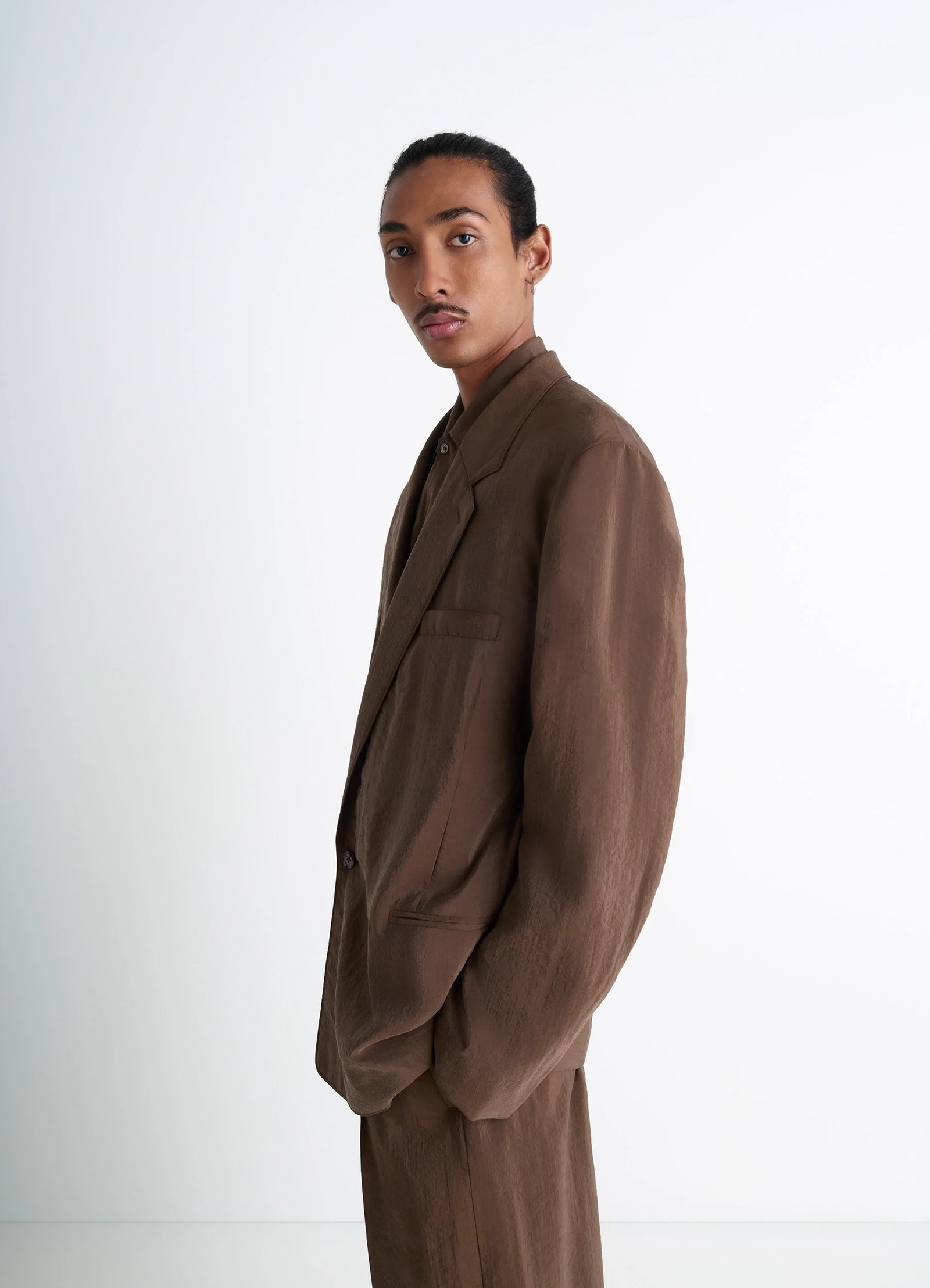 Lemaire soft double-breasted jacket in heather brown dry silk blend, model shot, three-quarter side vie oversized fit, left p