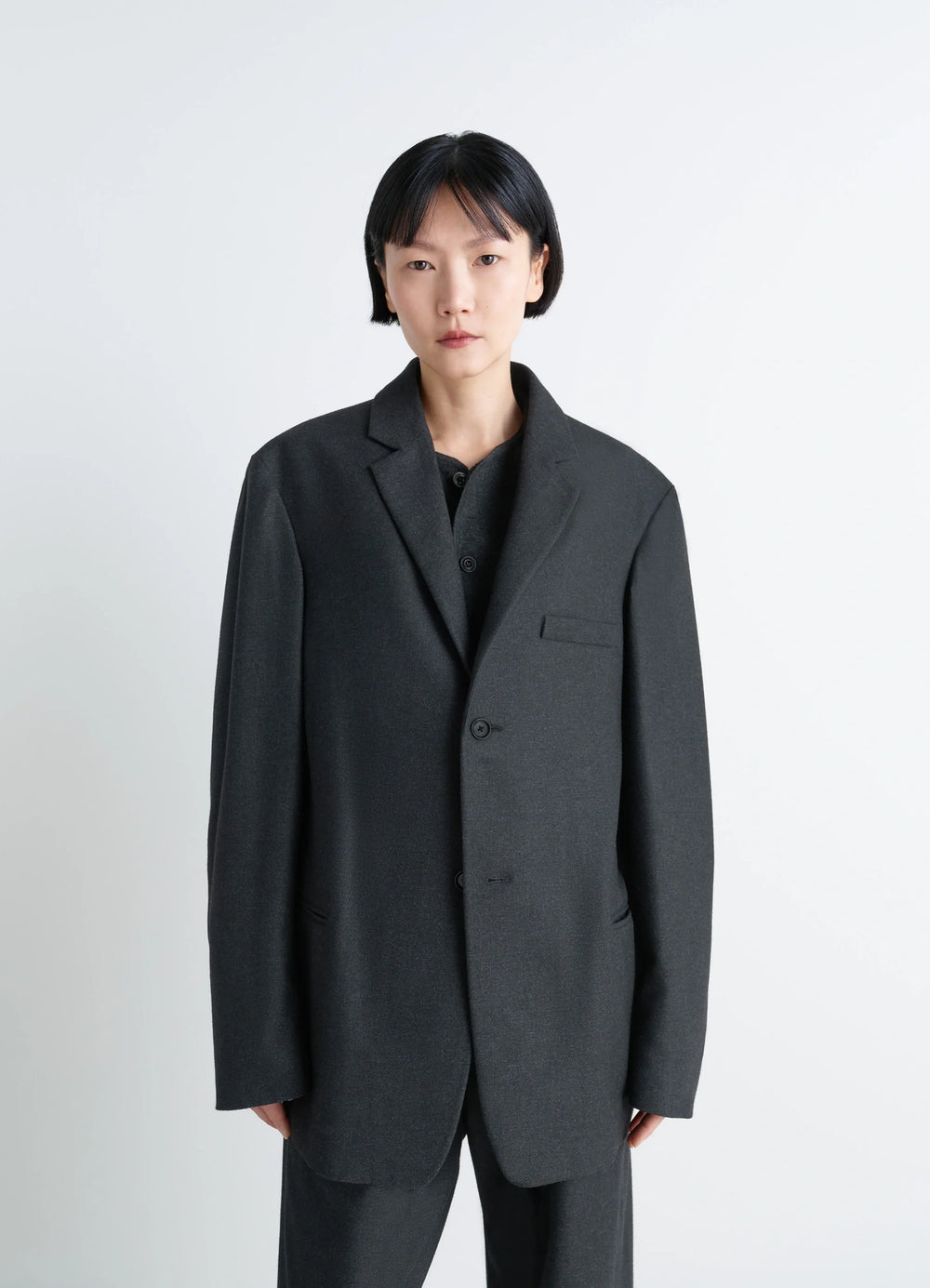 Lemaire Soft Single Breasted Jacket in Lightweight Cashmere-Blend, model shot, waist-up view minimalist silhouette