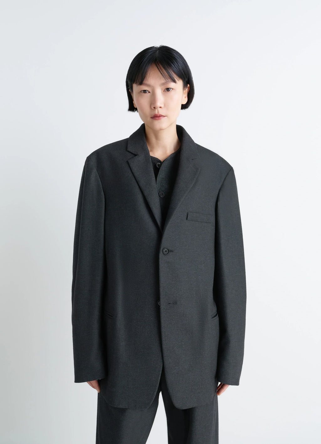 Lemaire Soft Single Breasted Jacket in Lightweight Cashmere-Blend, model shot, waist-up view minimalist silhouette