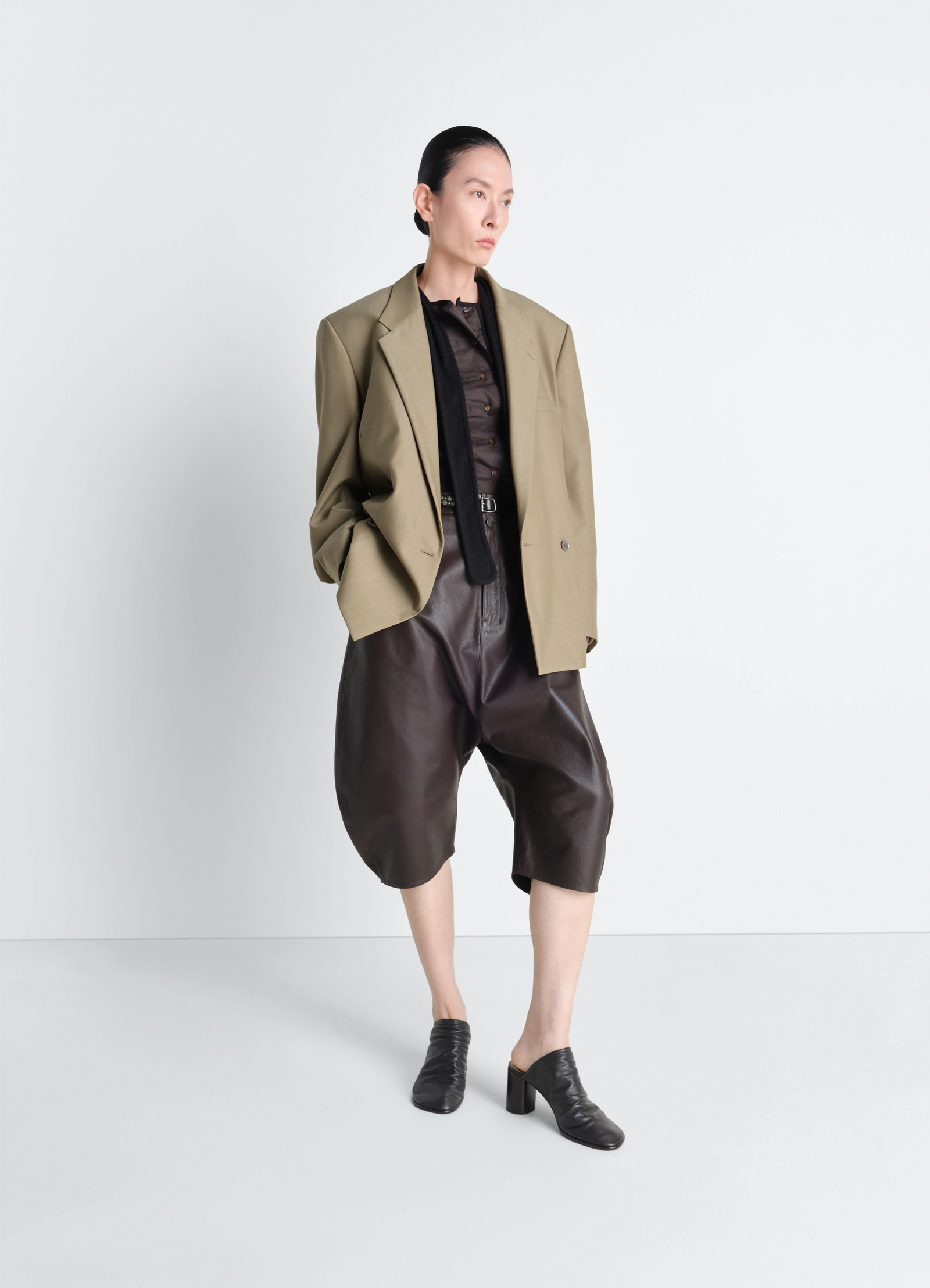 Double breasted tailored jacket in tropical polywool, model shot, three-quarter view oversized fit