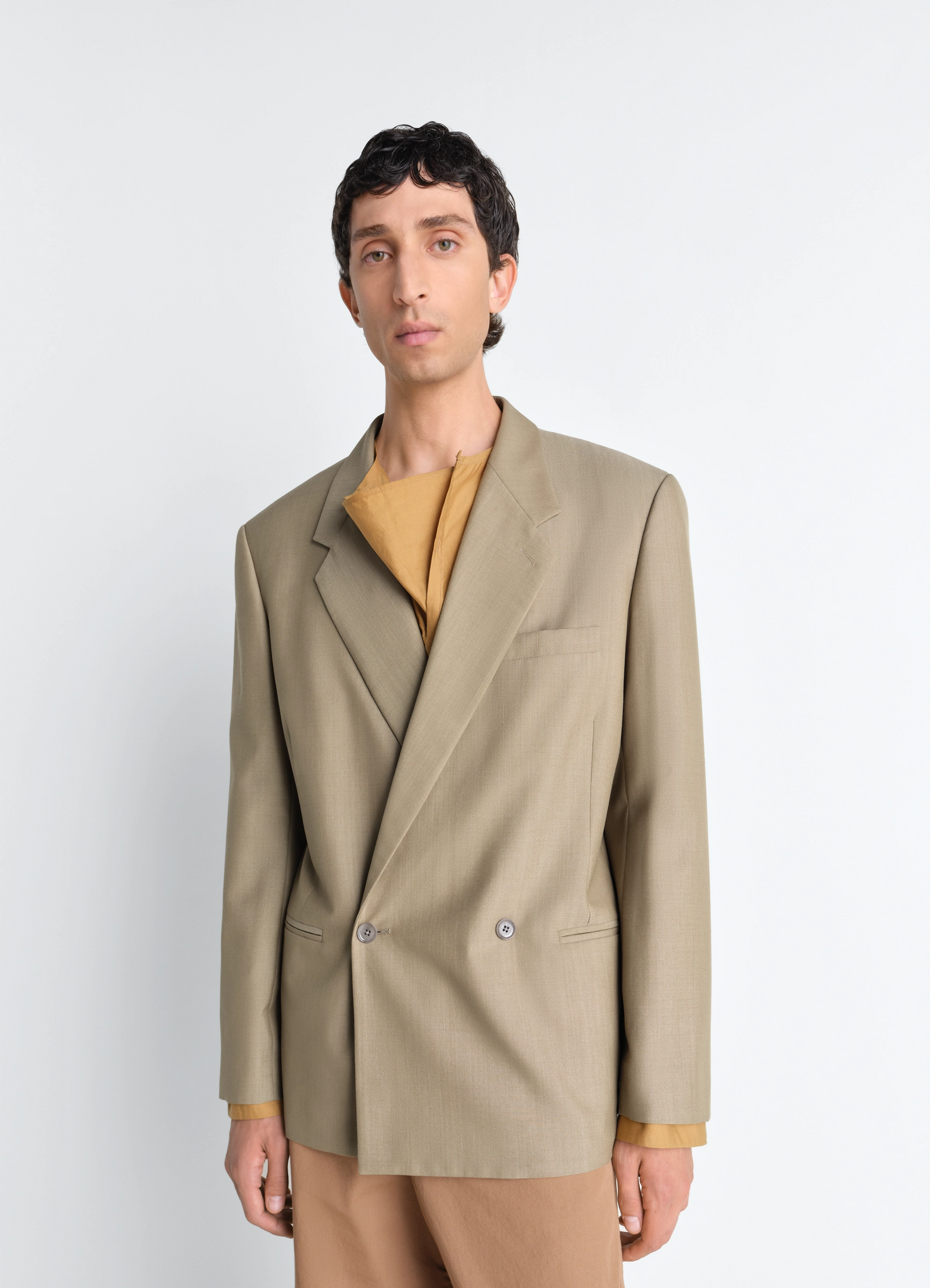 Double breasted tailored jacket in tropical polywool, model shot, half-body side view sharp shoulder detail