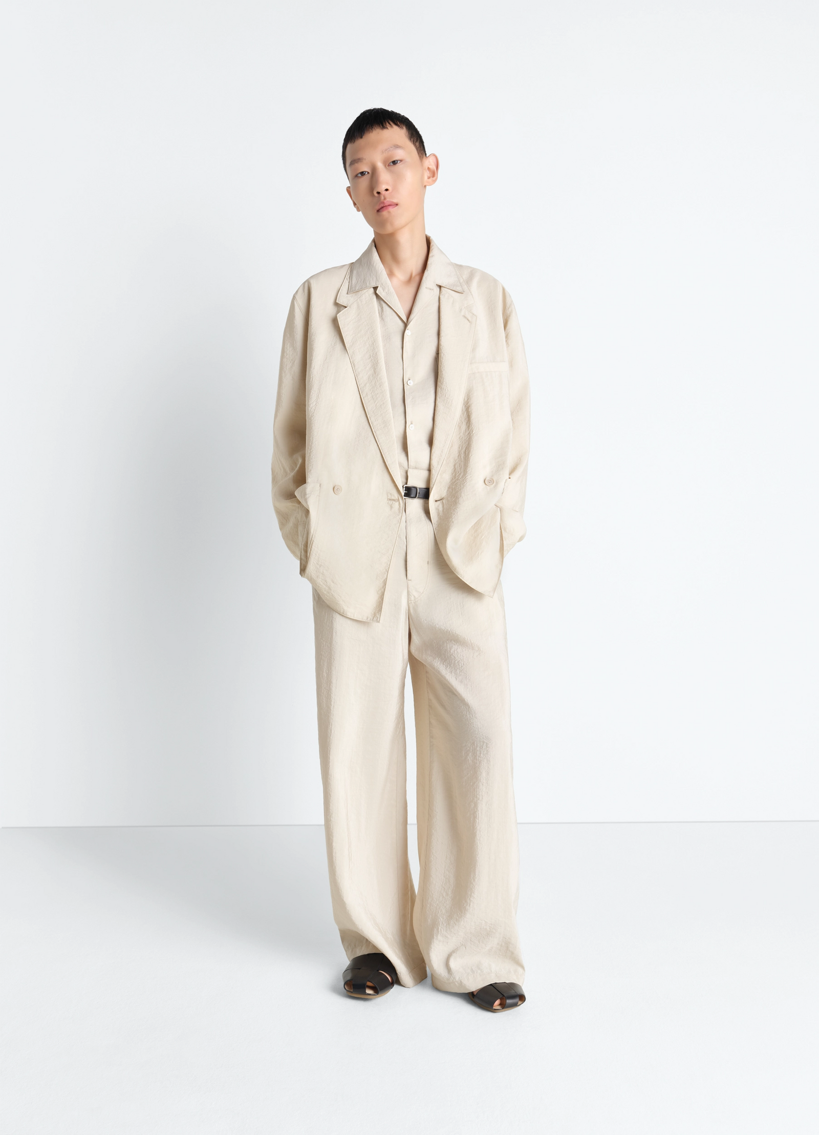 Soft double breasted jacket in dry silk, model shot, full body side view relaxed fit