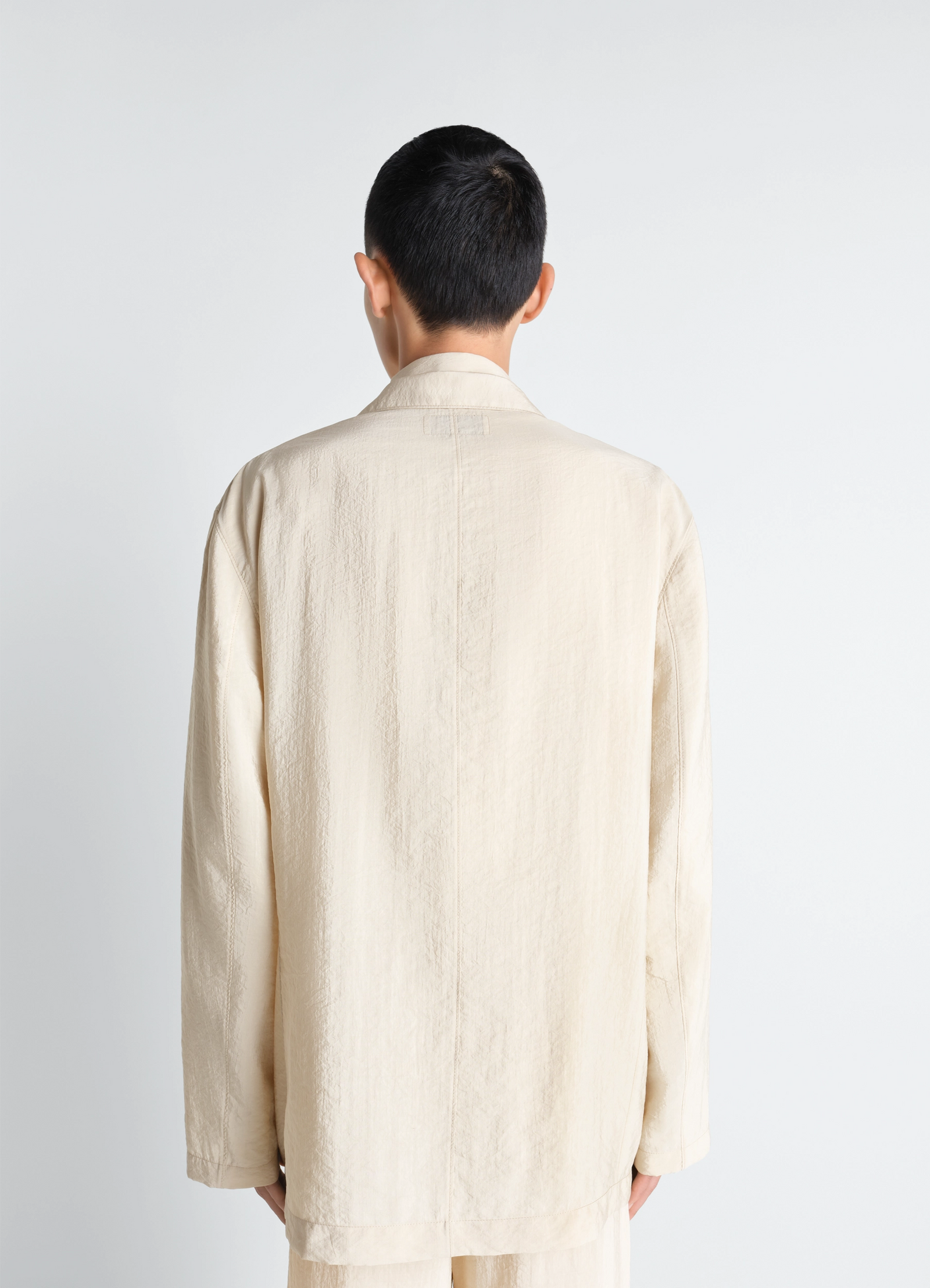 Soft double breasted jacket in dry silk, model shot, back view straight cut