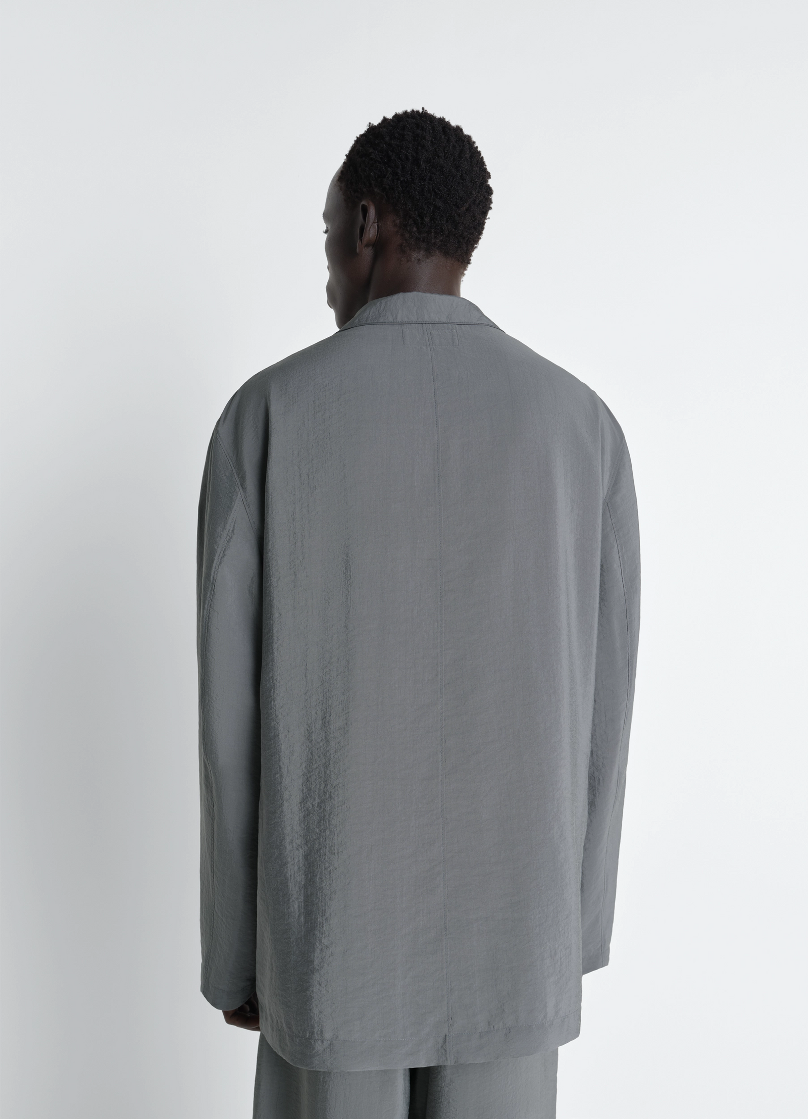 Soft double breasted jacket in dry silk, model shot, back view soft shoulder seam